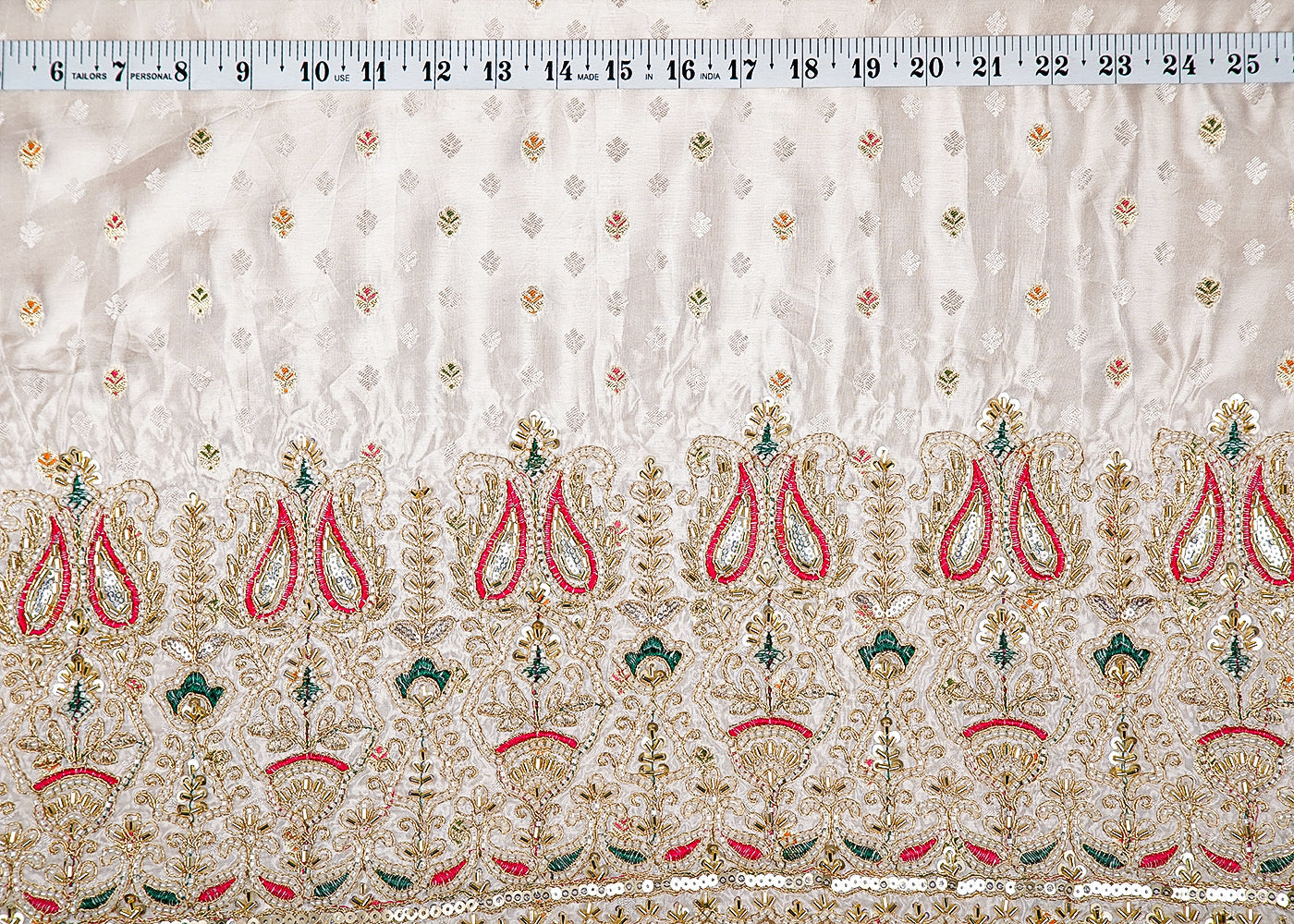 White Silk Fabric With All Over Zari Buti With One Side Zari, Thread and Sequins Work and Scalloped Border 15999