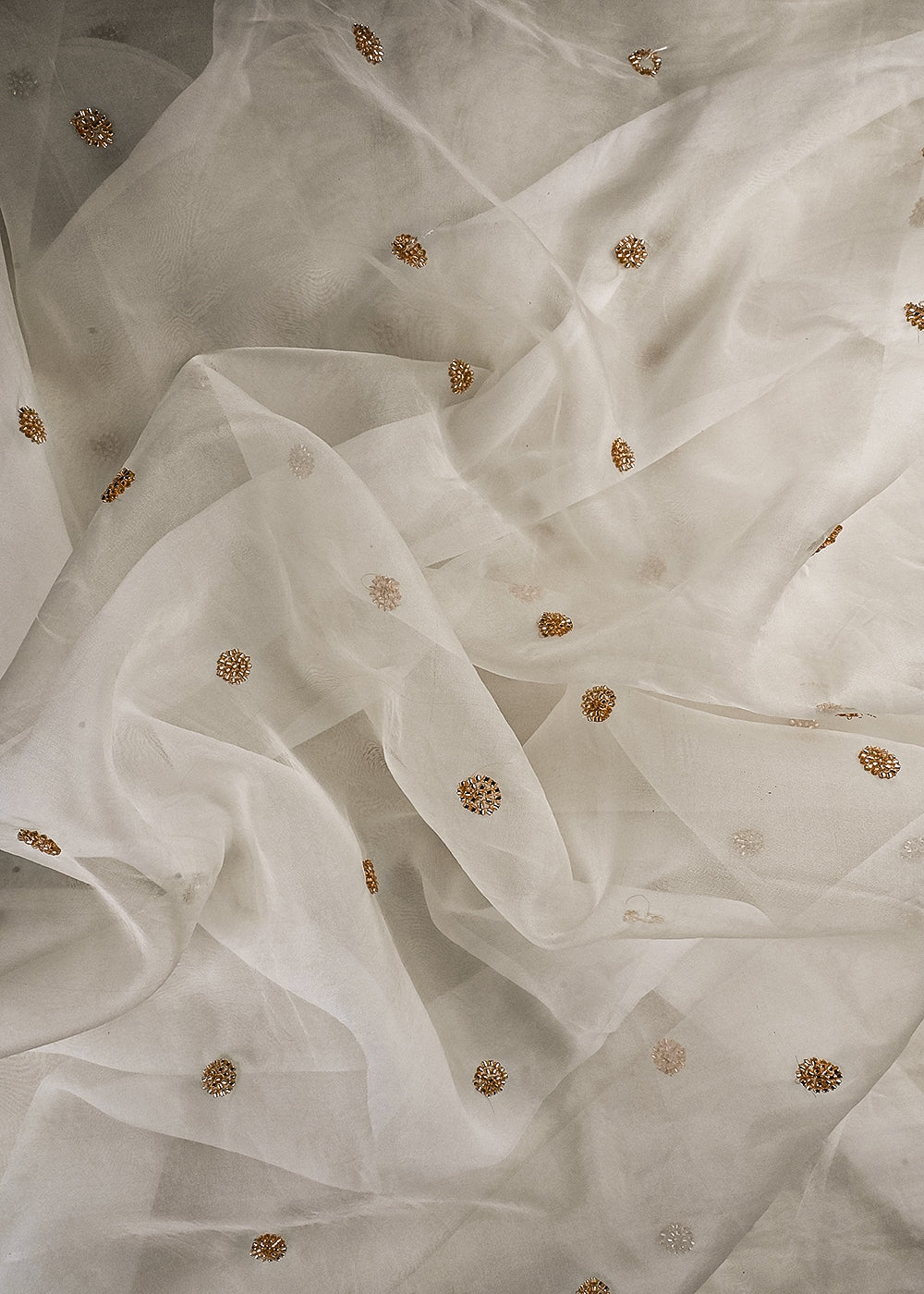 White Dyeable Organza Fabric With All Over Buti Of Katdana Work 25184