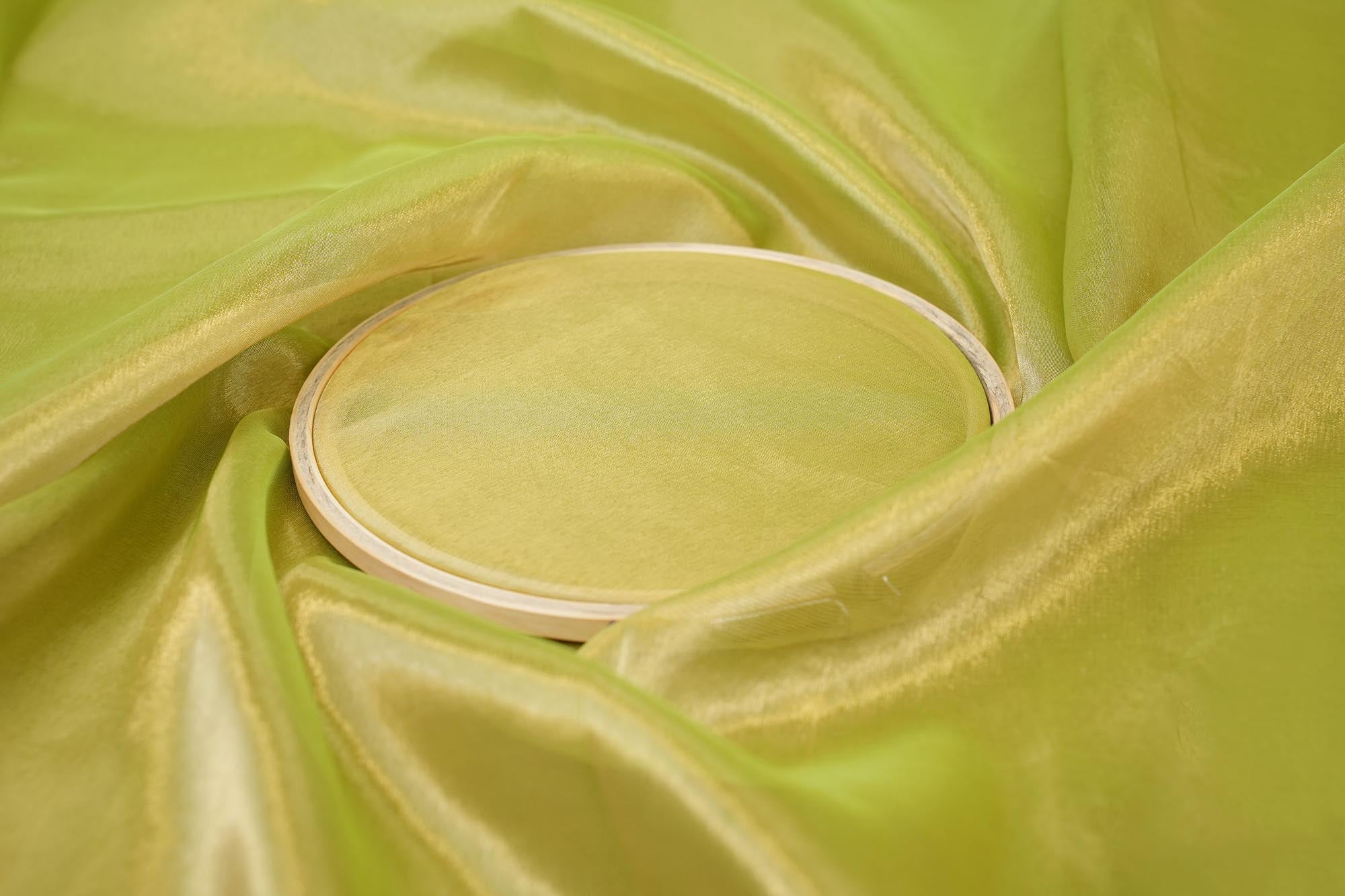 Light parrot green coloured tissue fabric with golden shimmer