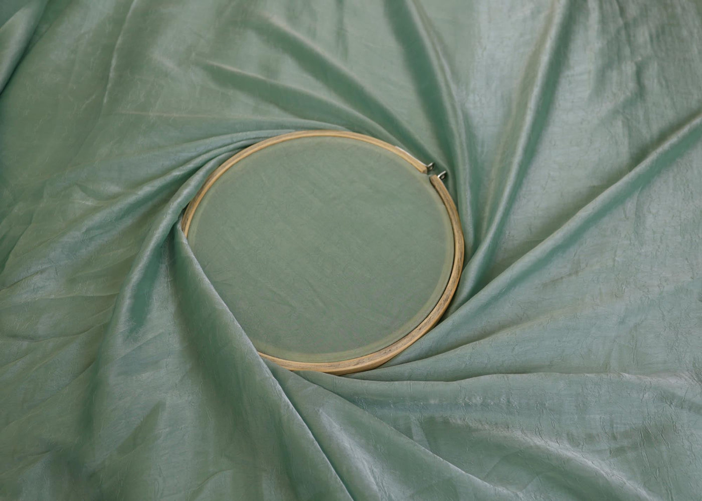 Sea green coloured silk crushed texture fabric - Paras Gallery Fabrics