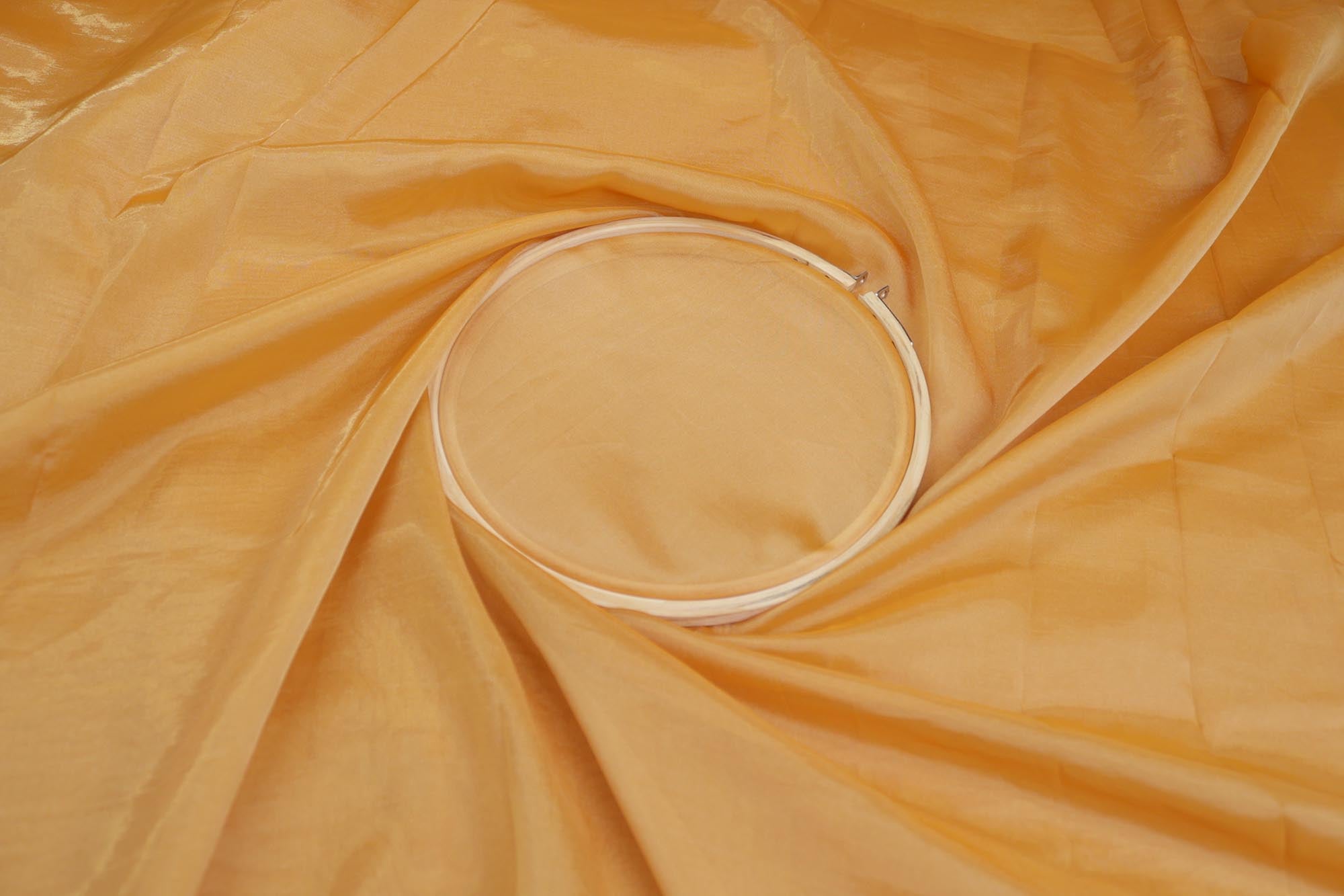 Mustard light coloured Soft tissue tissue fabric with gold shimmer