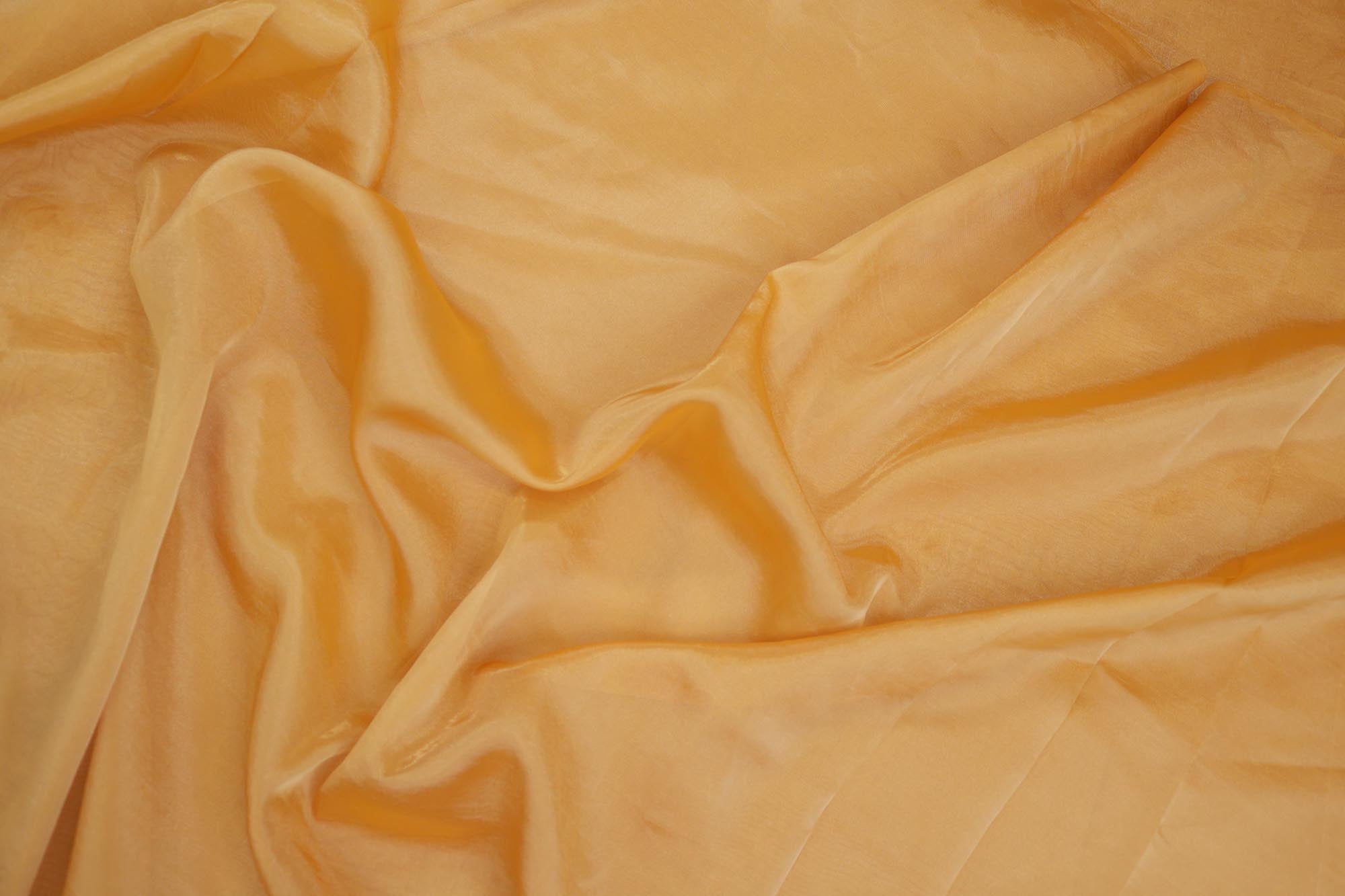 Mustard light coloured Soft tissue tissue fabric with gold shimmer