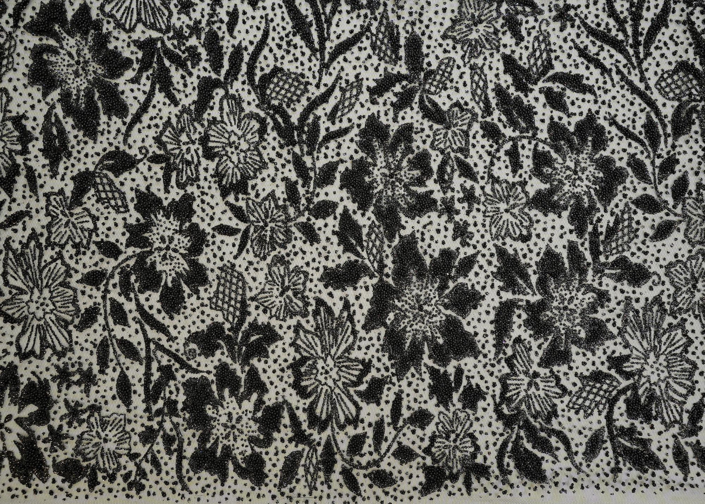 Black net with floral pattern using beads with beads and glitter allover on fabric