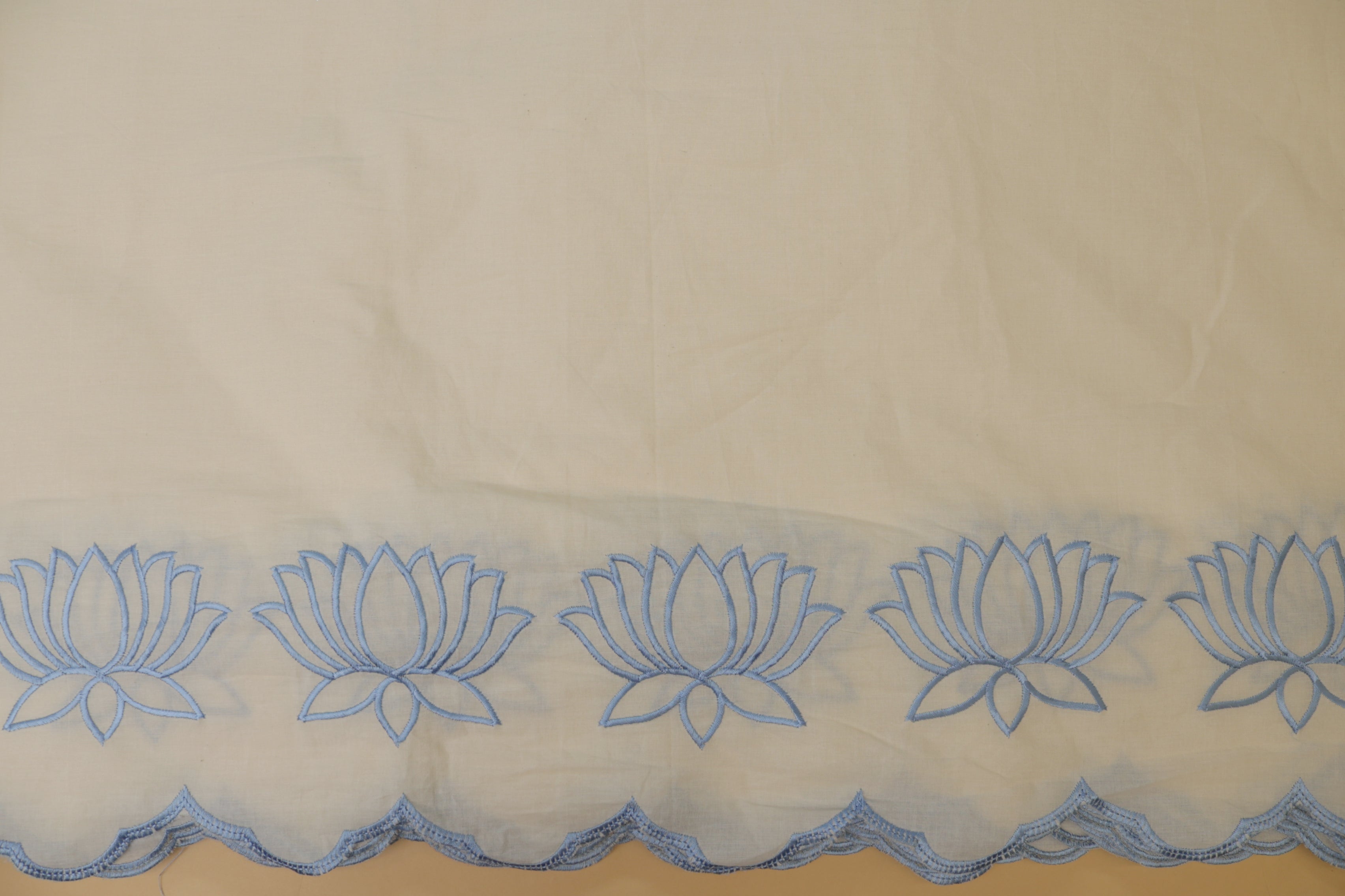 Sky blueFloral patter thread work and cut work on border on cotton fabric