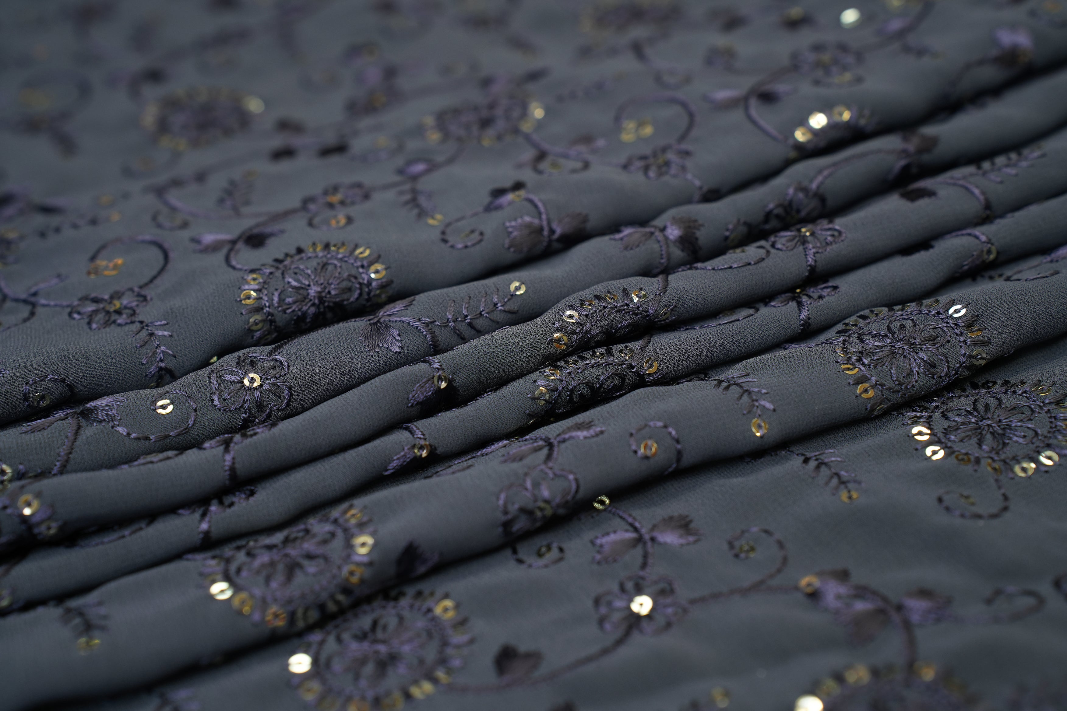 Thread work with golden sequins creating floral overall pattern on ice grey georgette fabric