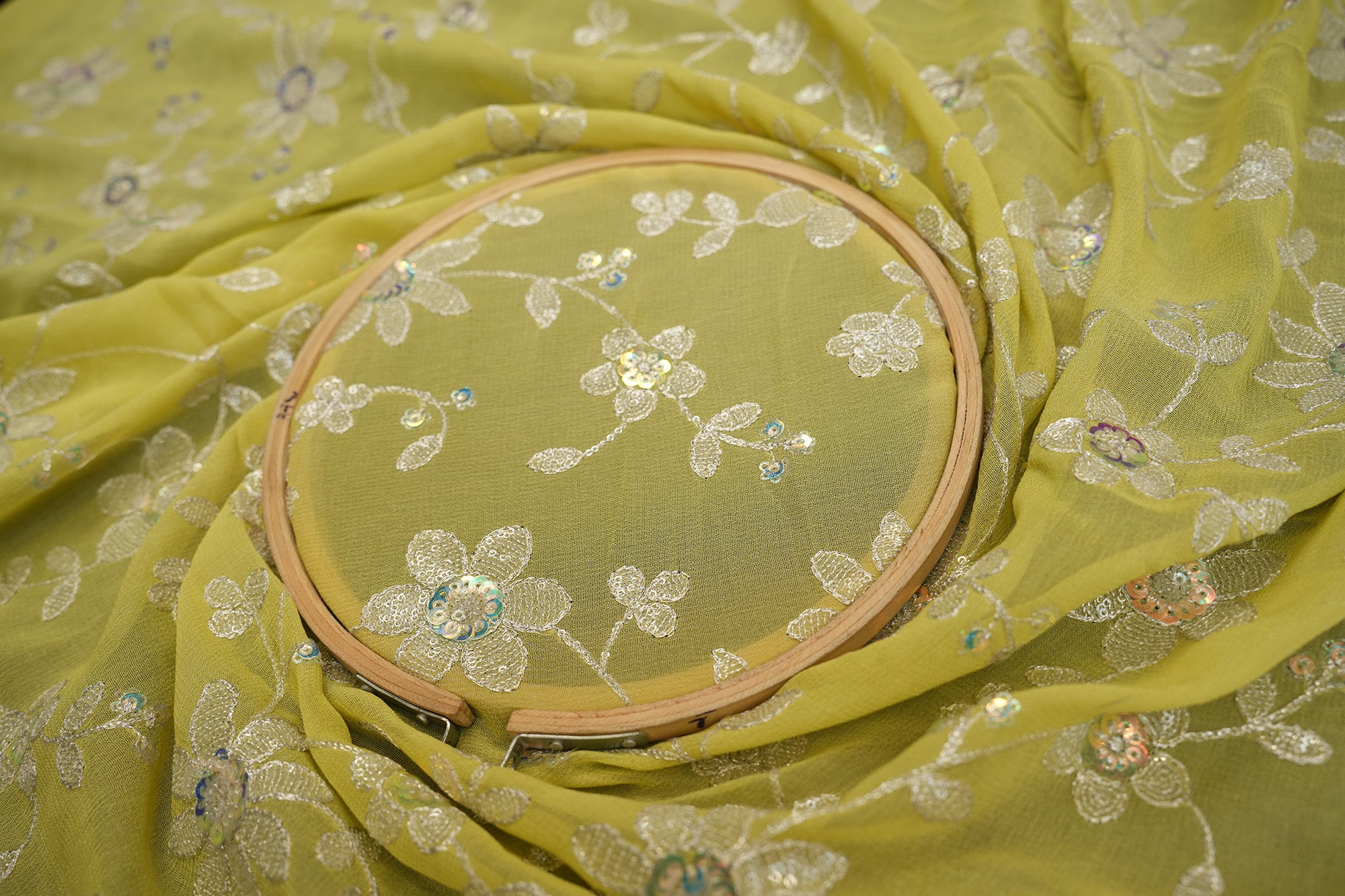 Lime Green Soft Georgette fabric with Zari and Sequins creating all over floral pattern