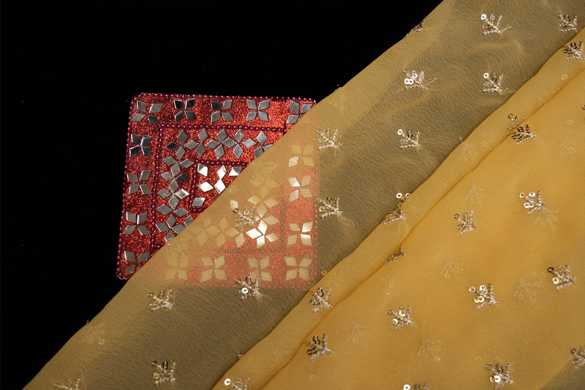 Yellow georgette fabric with golden sequins with golden zari small motif creating allover pattern