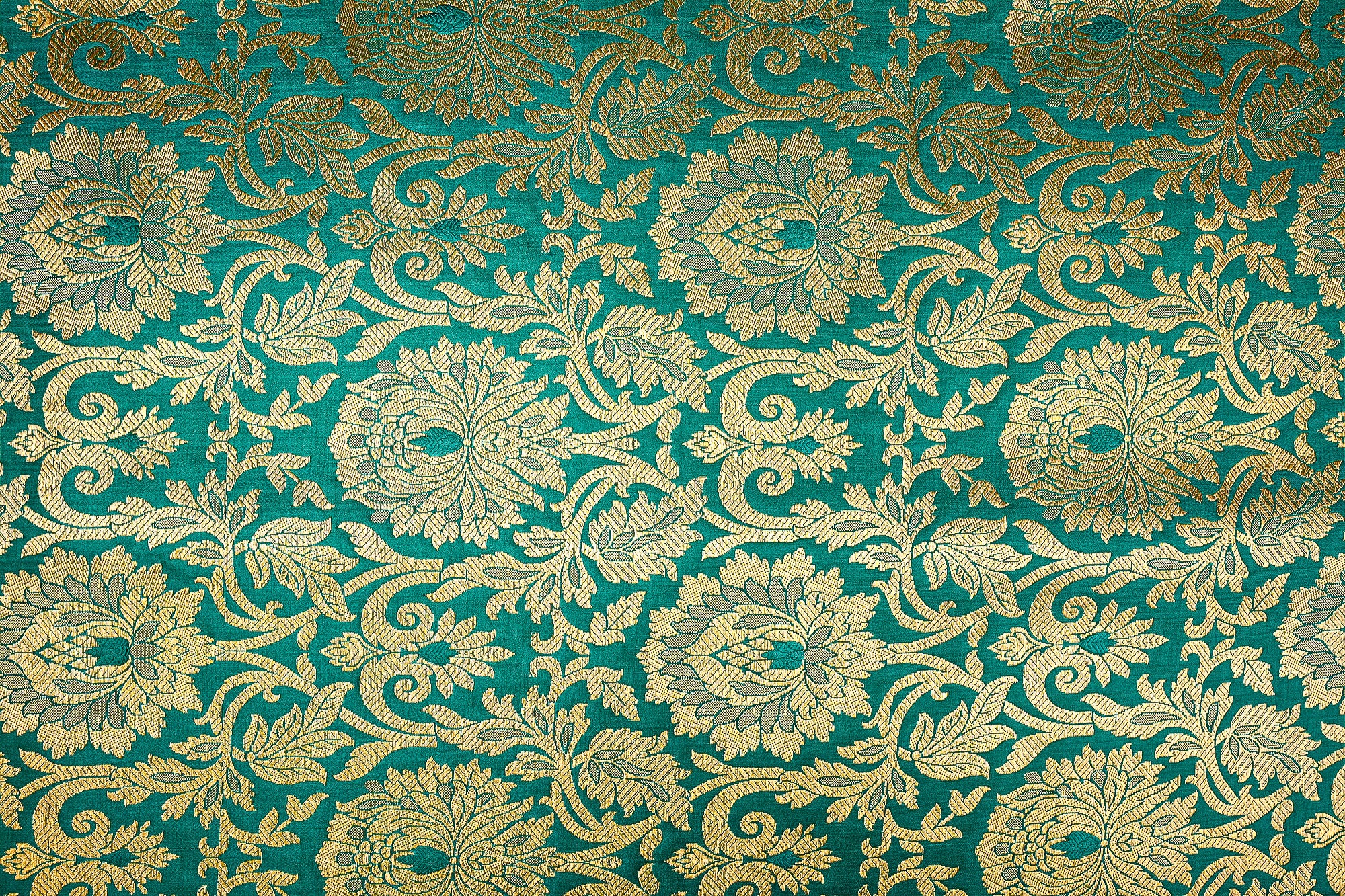 Elegant green Banarasi brocade featuring golden intricate patterns- Paras Gallery Fabrics