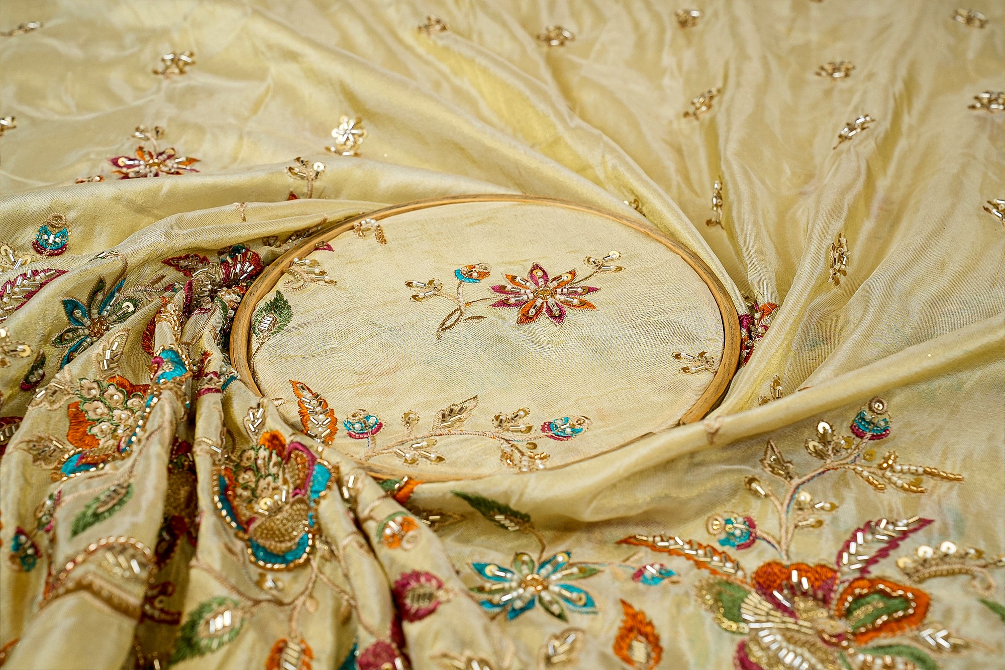 Golden Tissue Fabric with Heavy Floral Border of Sequins, Beads, Kutdana, and Threadwork