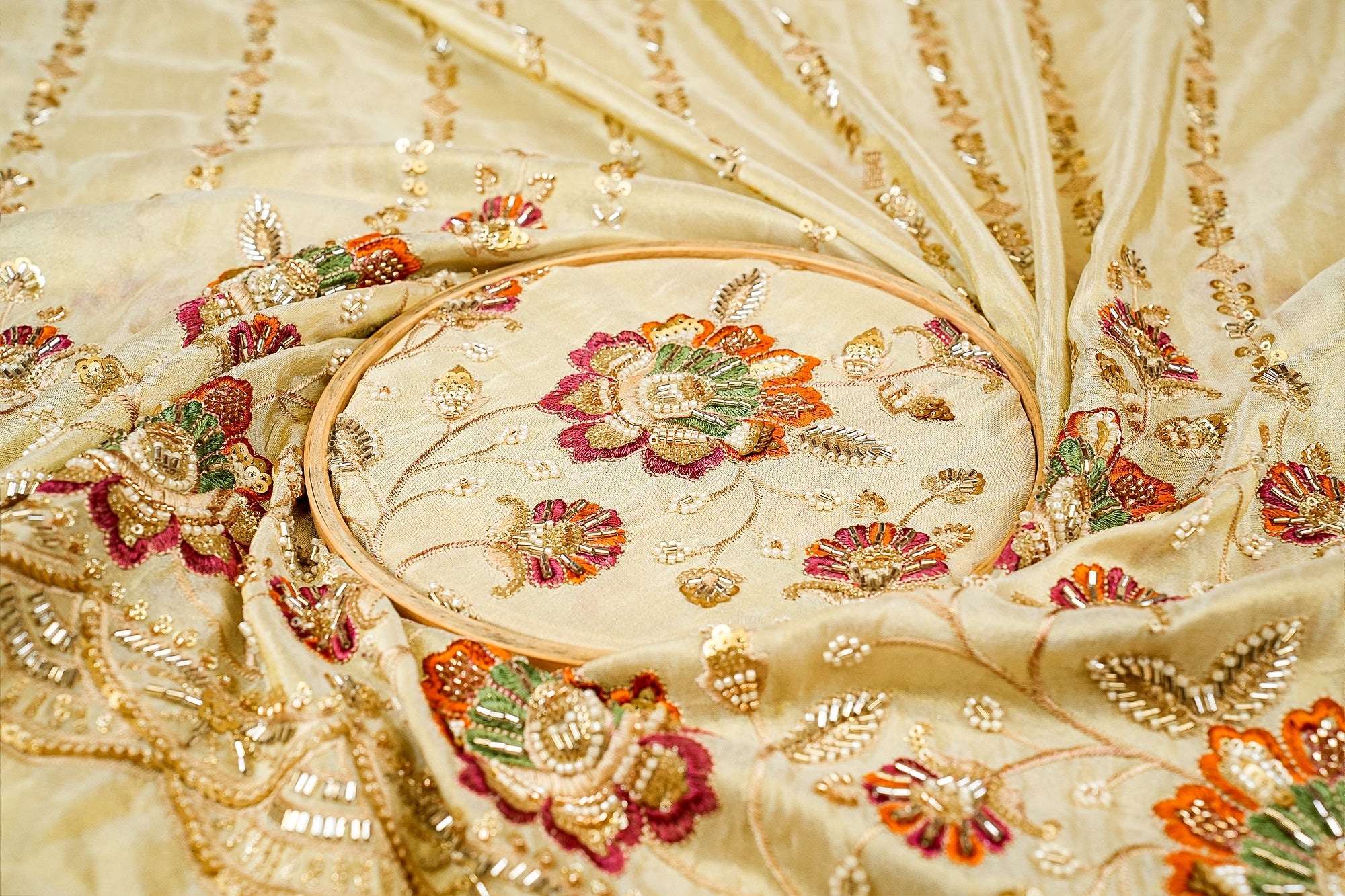 Golden Tissue Fabric with Heavy Floral Border of Sequins, Beads, Kutdana, and Threadwork