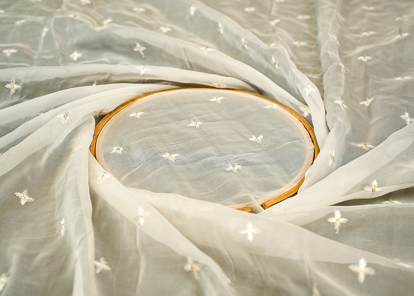 Radiance Organza Fabric with All-Over Buti of White Thread and Golden Sequins