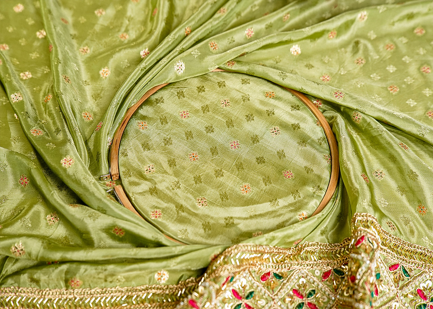 Pista Green Silk Fabric With All Over Zari Buti With One Side Zari, Thread and Sequins Work Border 16002