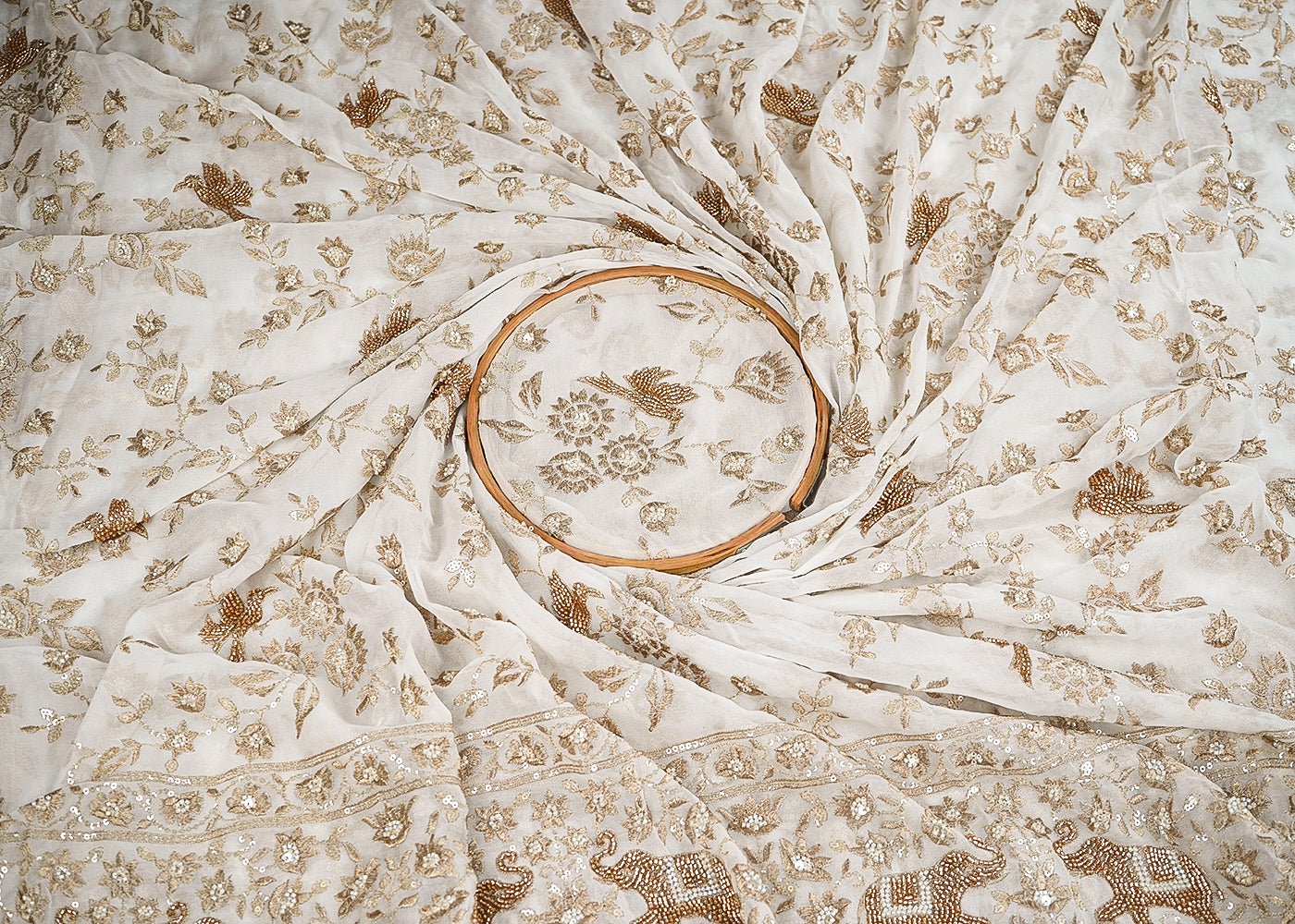 White Georgette Fabric With All Over Bird Motif Of Zari, Sequins, Katdana And Bead Work With One Side Elephant Motif Border 19989