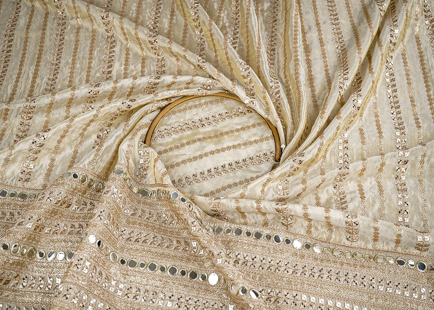 Golden Dyeable Tissue Fabric With All Over Stripes of Zari, Sequins And Faux Mirror Work With One Side Heavy Border 21506