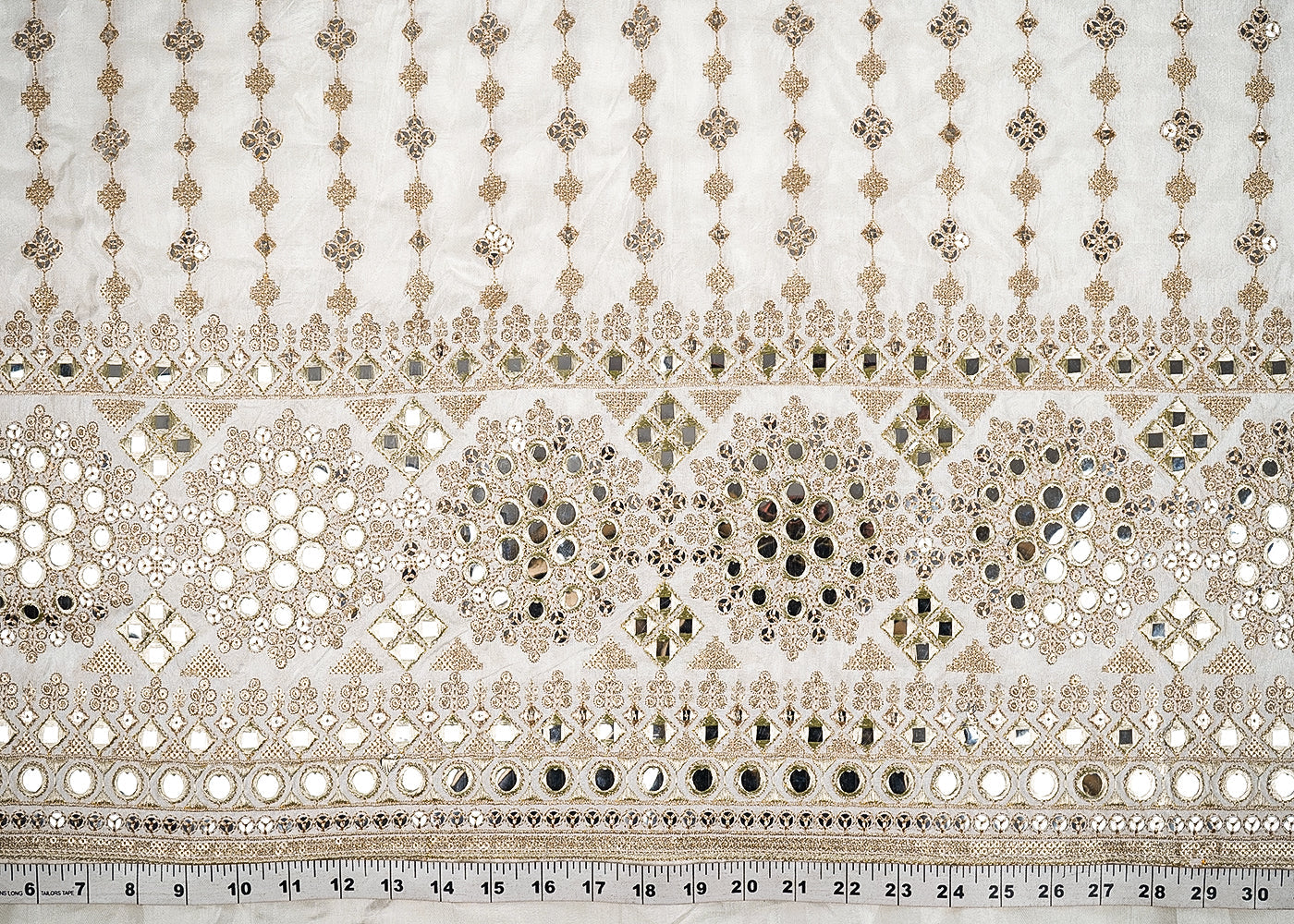 White Dyeable Silk Fabric With All Over Zari, Faux Mirror And Sequins Work With One Side Heavy Border 21586