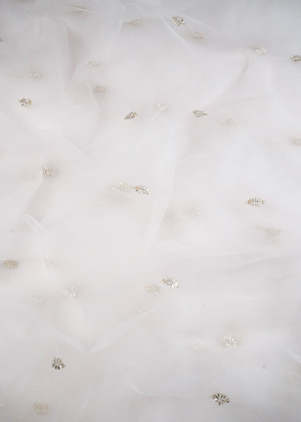 White Dyeable Net Fabric With All Over Buti Of Sequins Work 24482