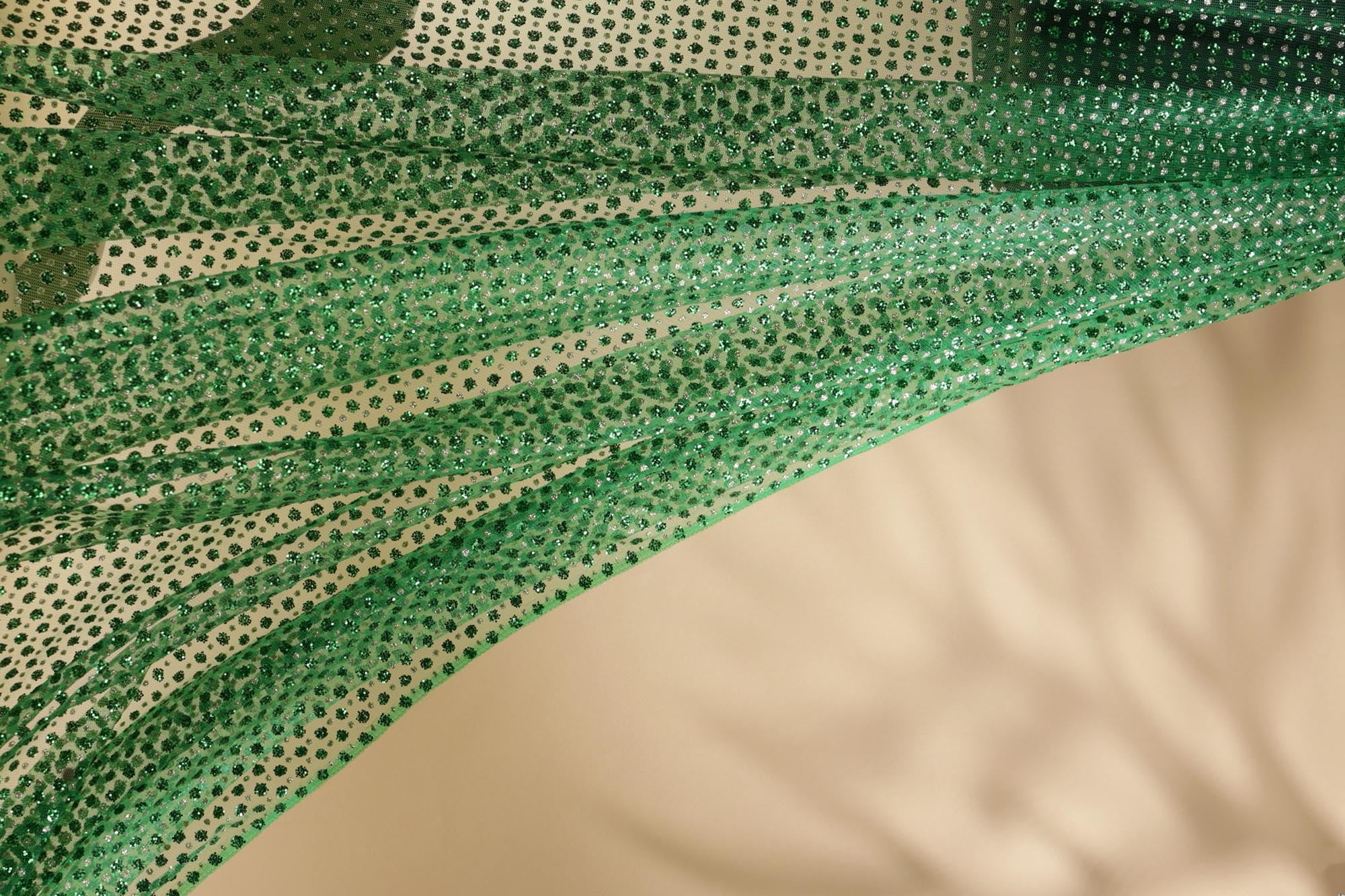 Green net with glitter overall creating abstract pattern