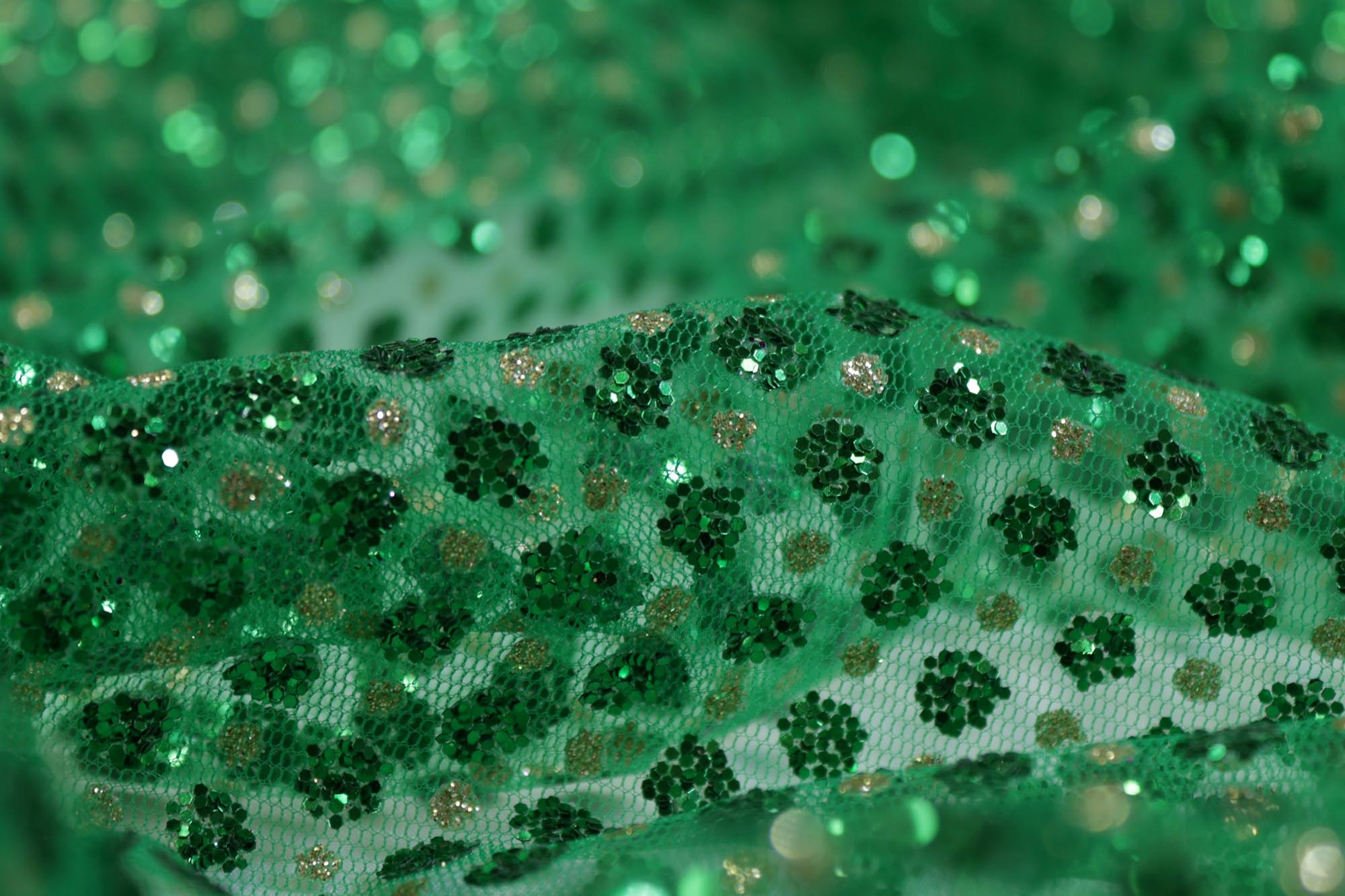 Green net with glitter overall creating abstract pattern