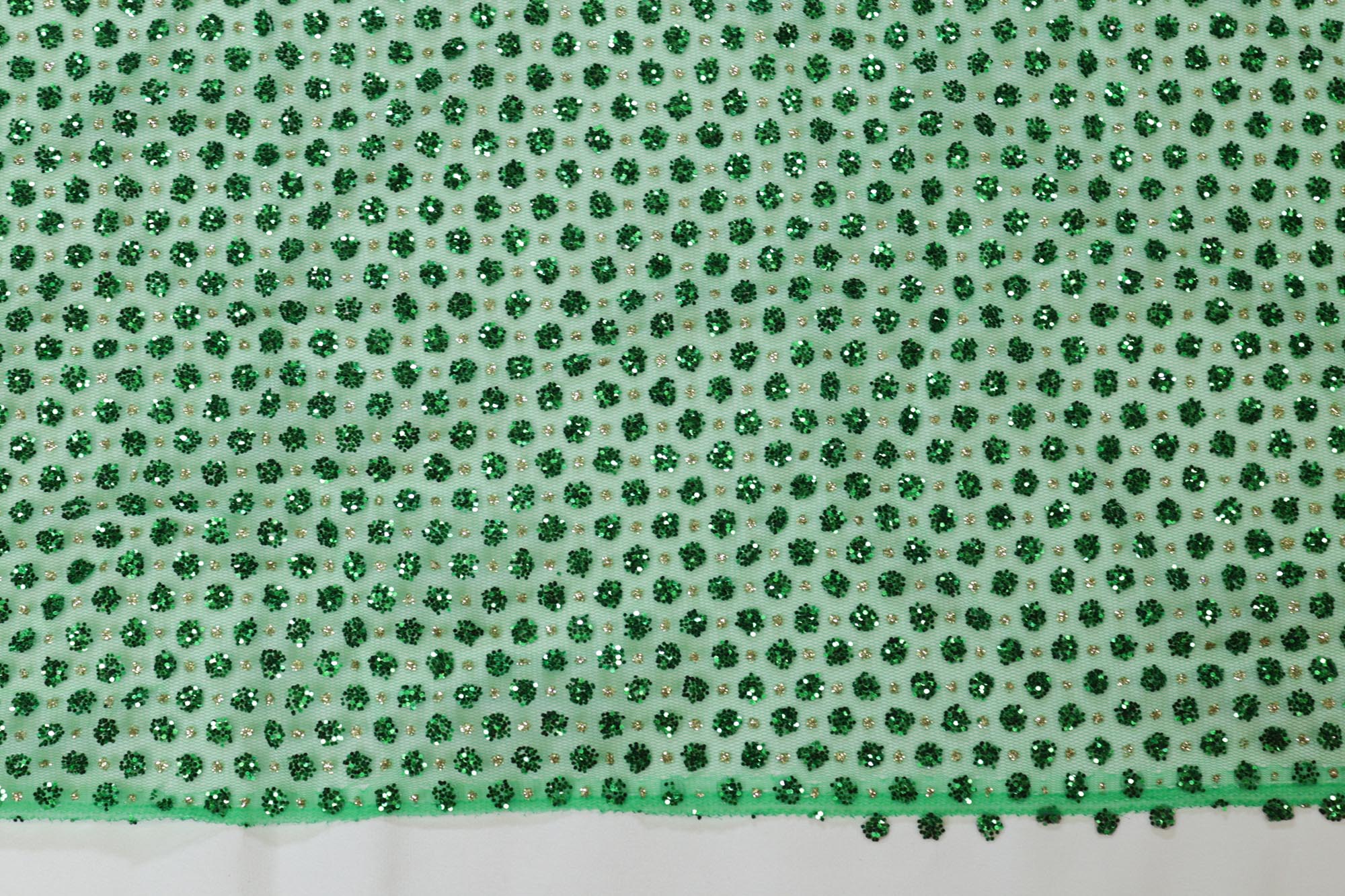 Green net with glitter overall creating abstract pattern