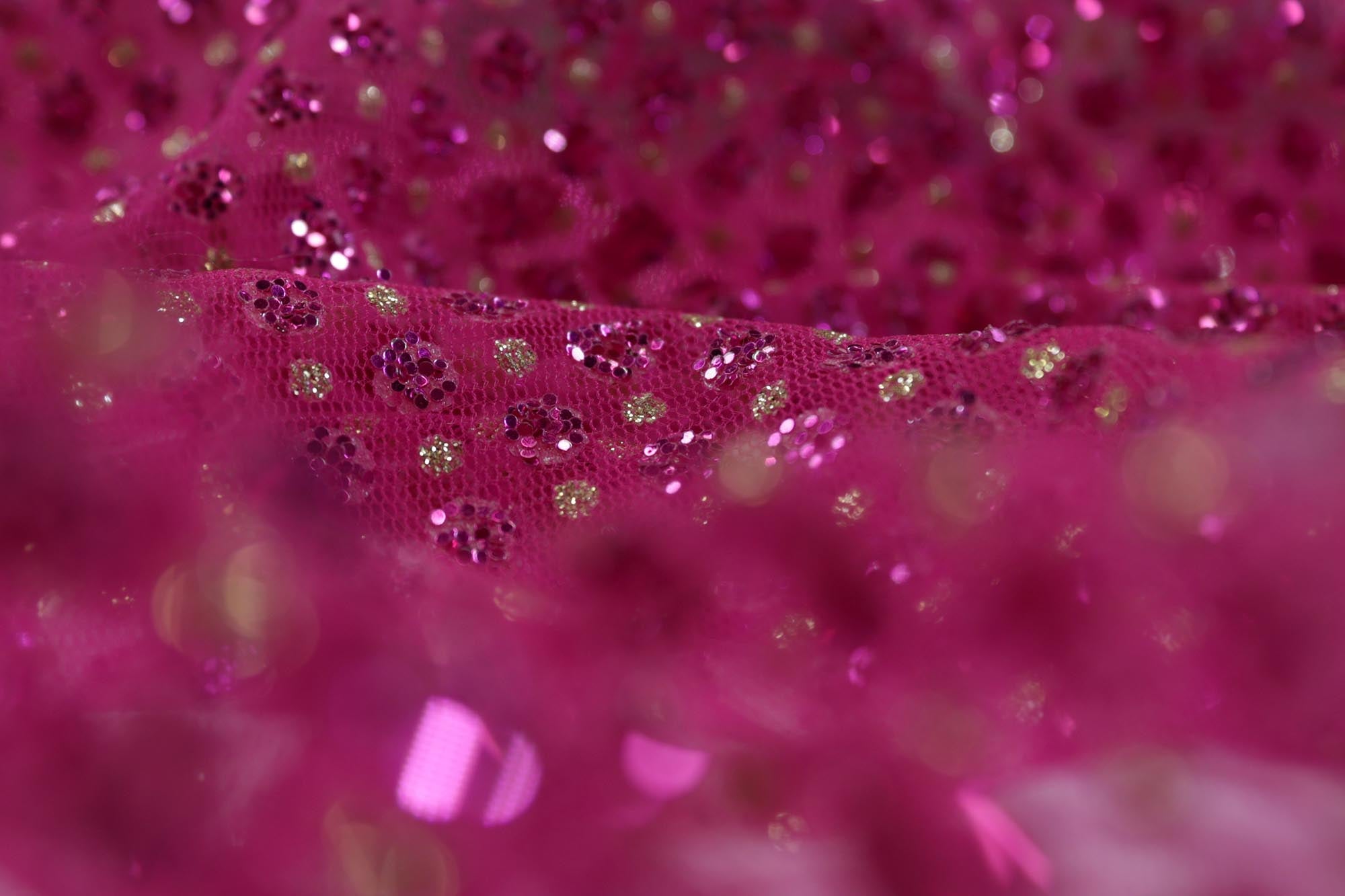 Hot pink net with glitter overall creating abstract pattern