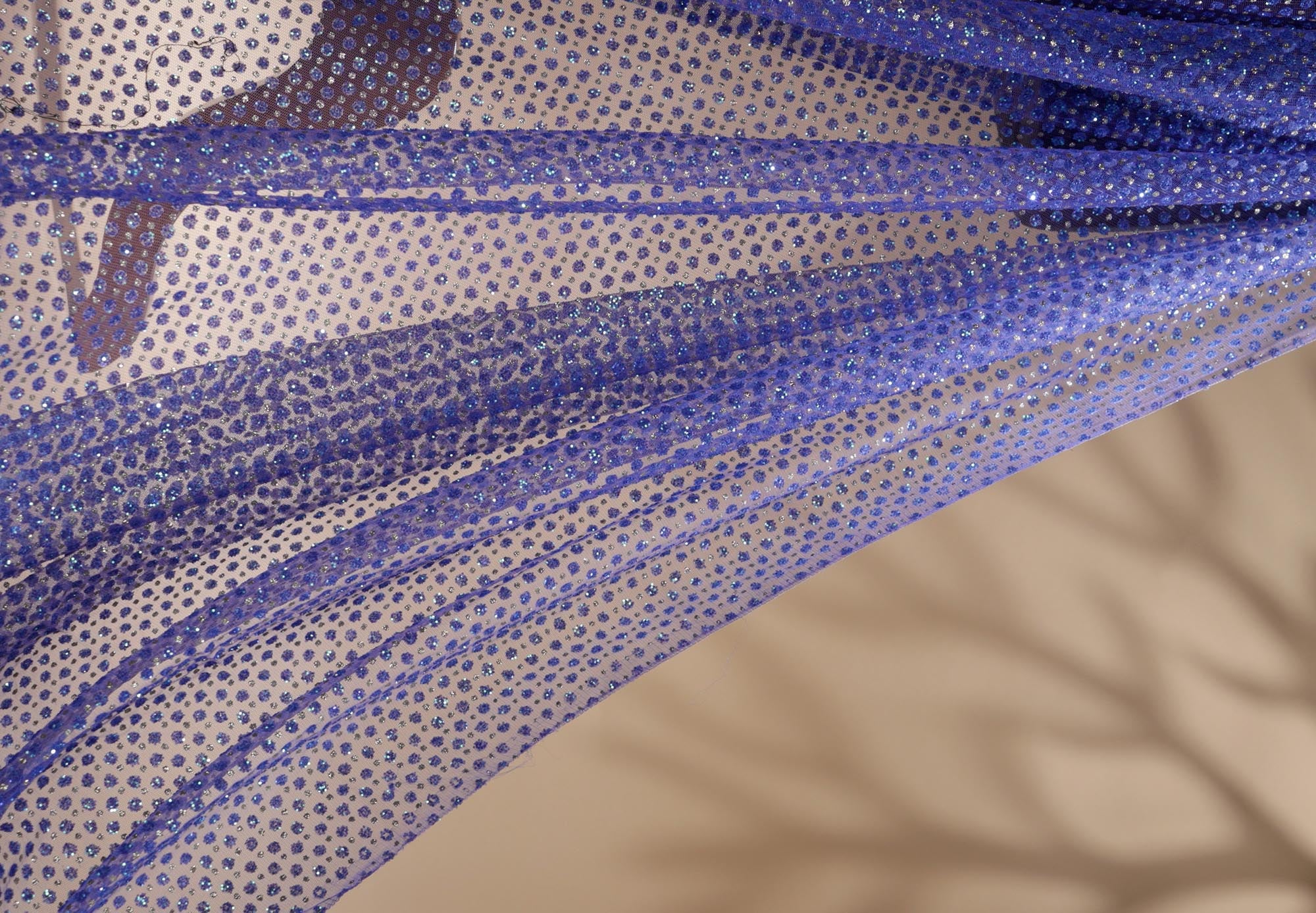 Blue net with glitter overall creating abstract pattern