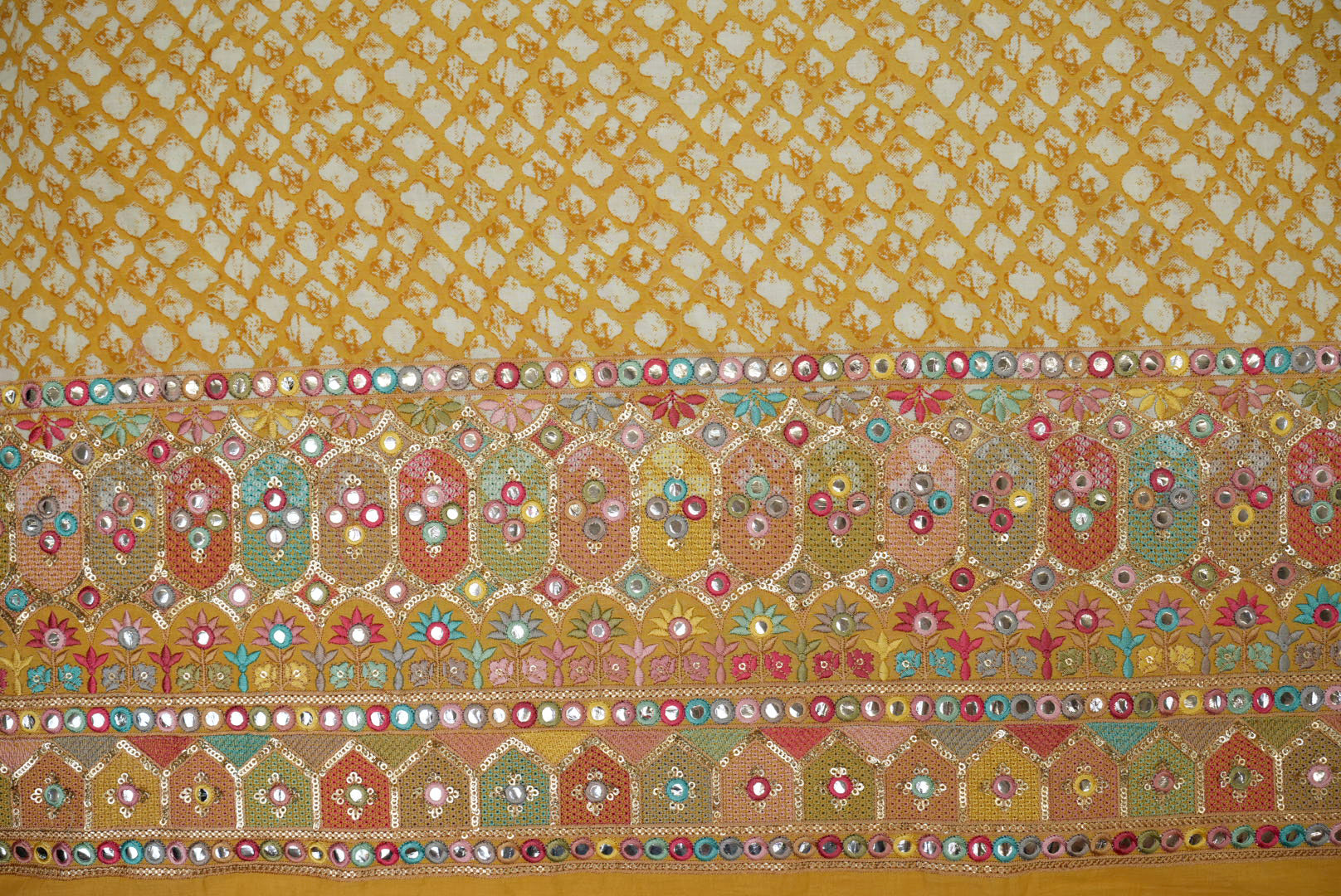 Yellow abstract printed cotton with multi colour thread with sequins and faux mirror on border