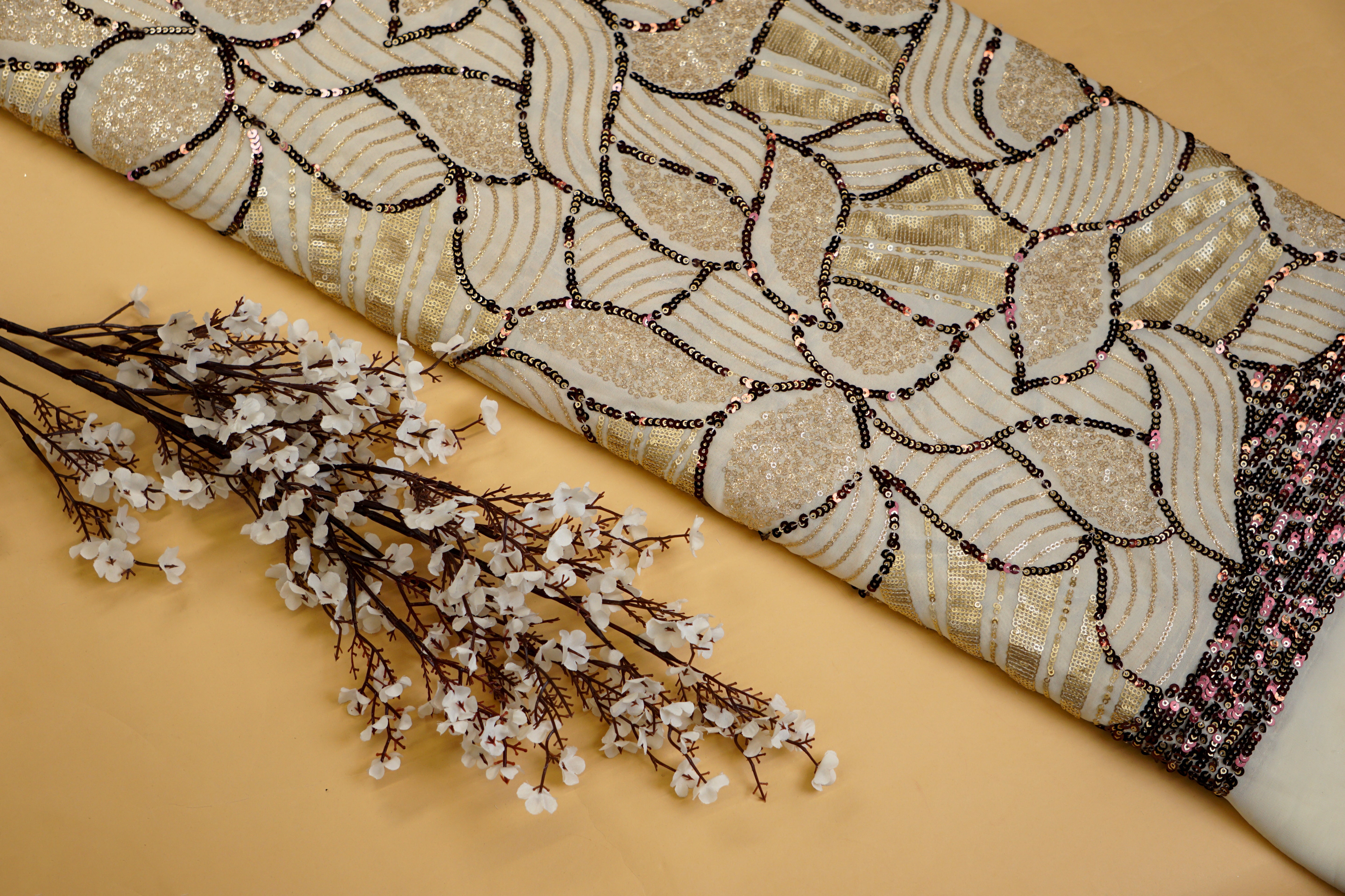 Beige glitter and antique sequins work creating abstract all over pattern on beige georgette fabric