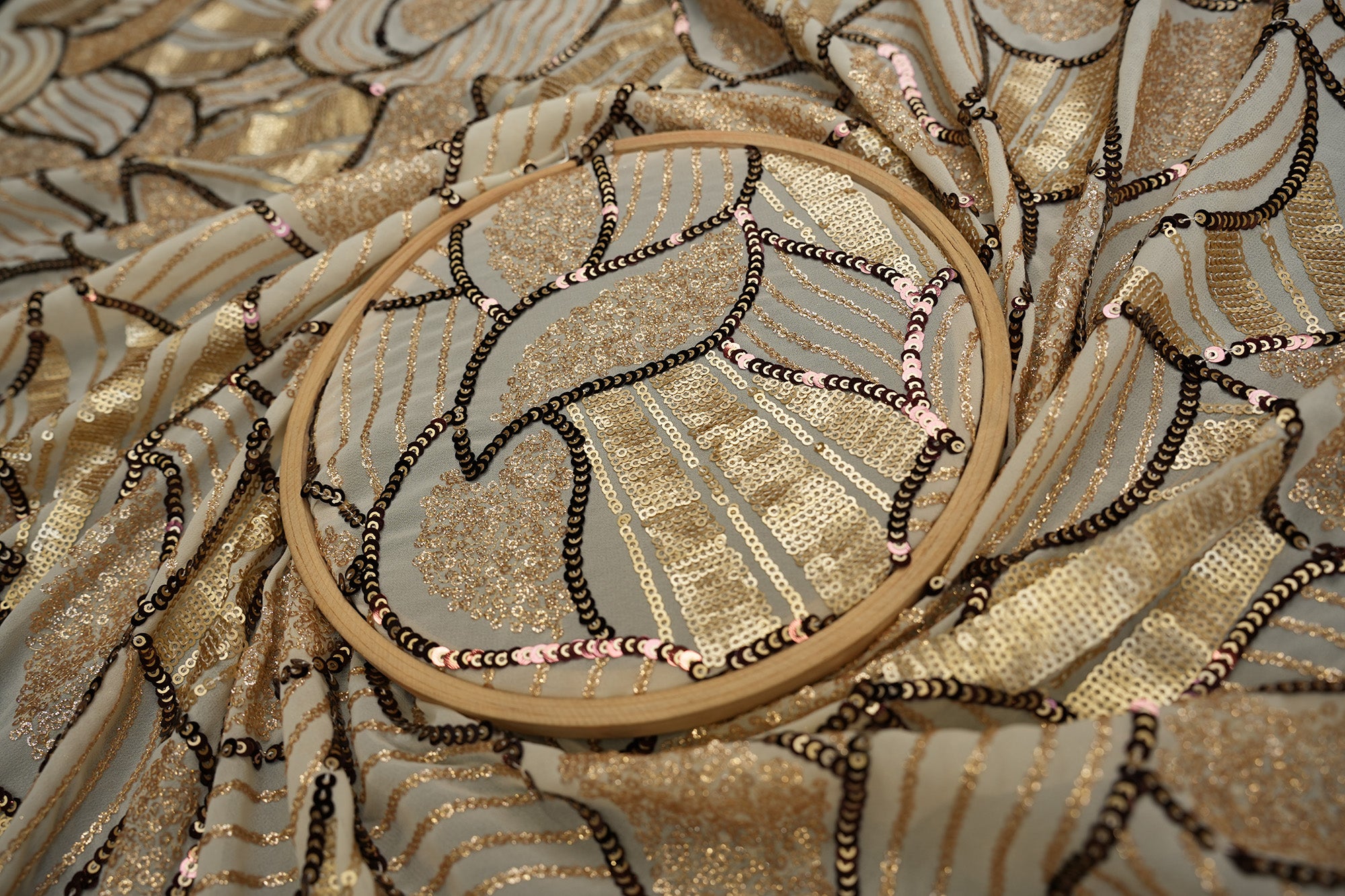 Beige glitter and antique sequins work creating abstract all over pattern on beige georgette fabric