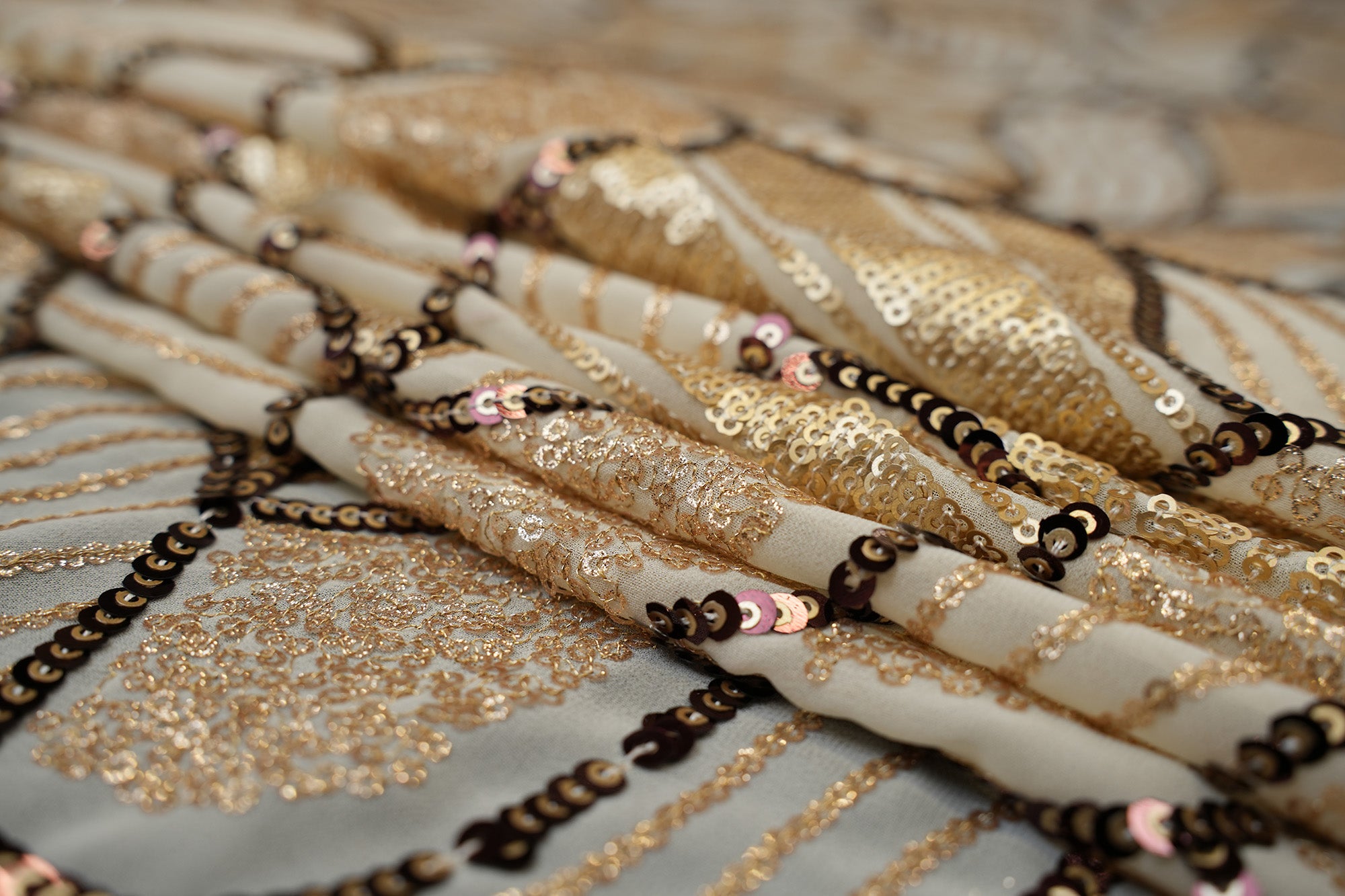 Beige glitter and antique sequins work creating abstract all over pattern on beige georgette fabric