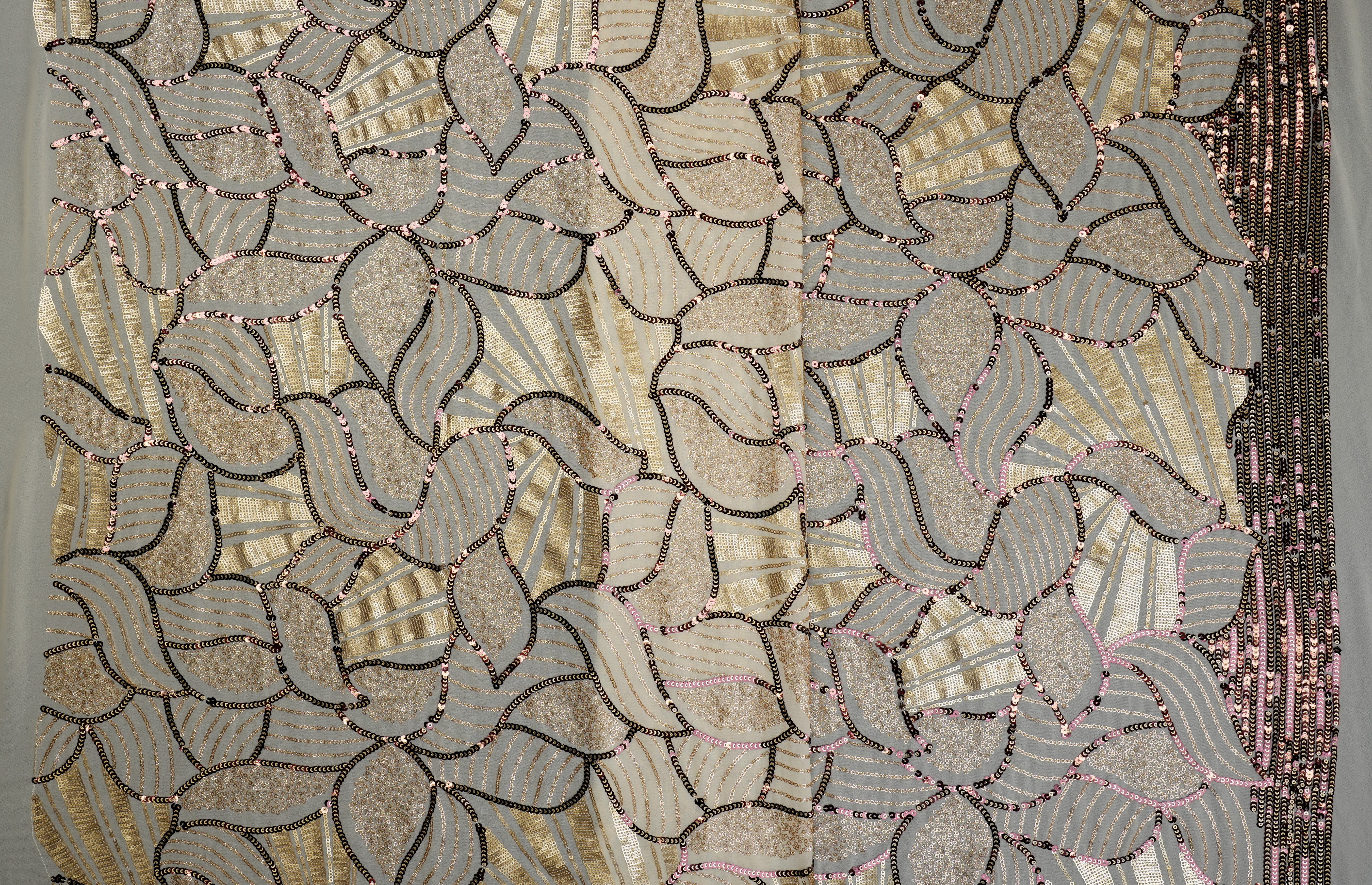 Beige glitter and antique sequins work creating abstract all over pattern on beige georgette fabric