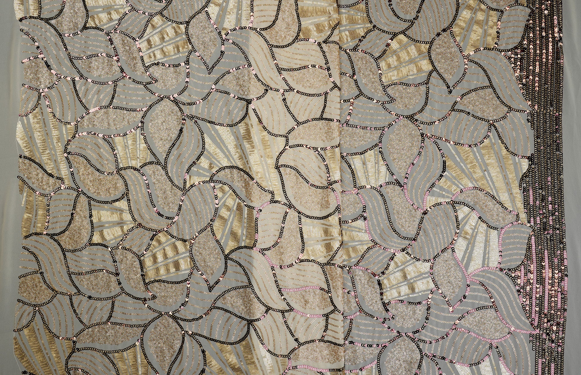 Beige glitter and antique sequins work creating abstract all over pattern on beige georgette fabric