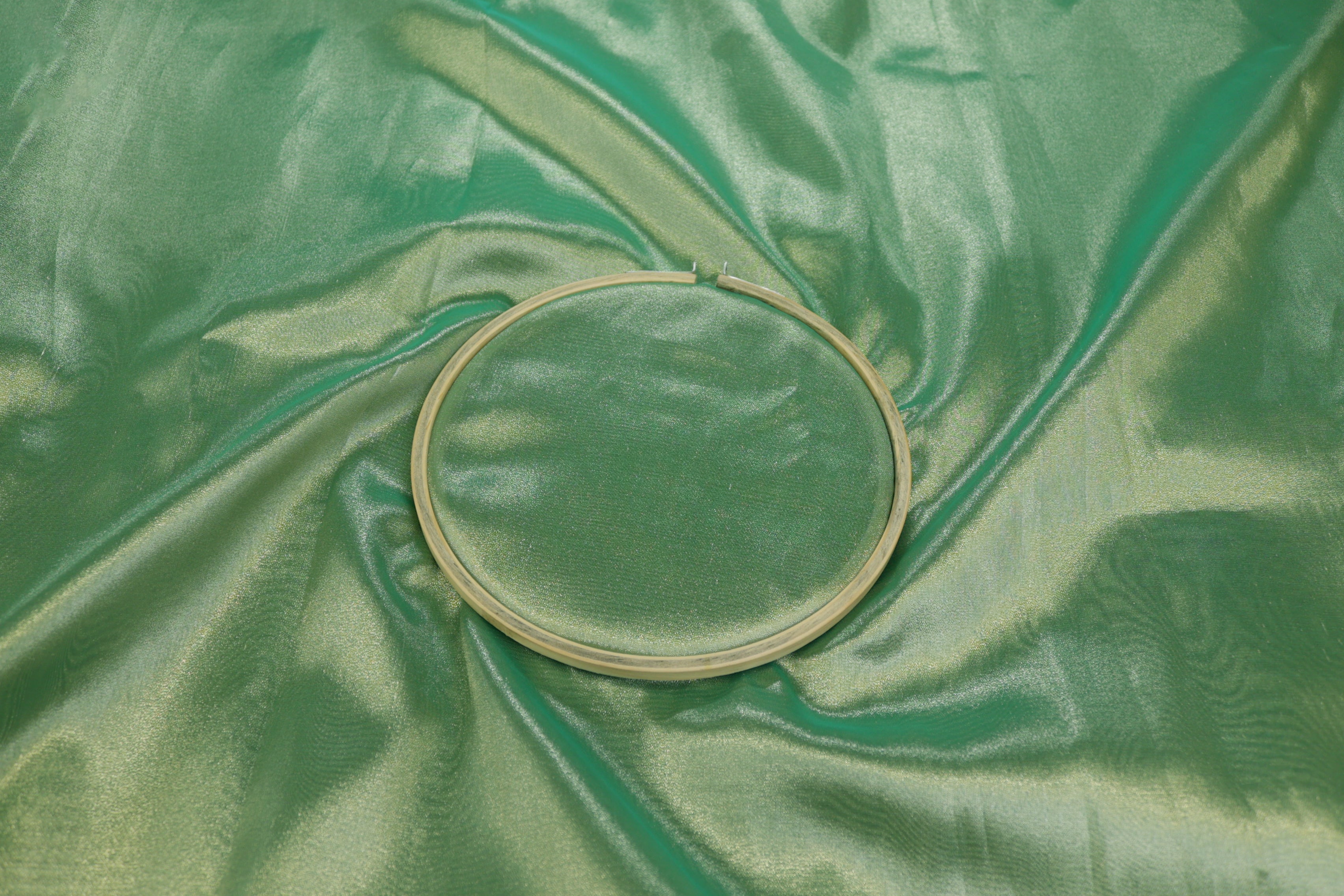 Light green coloured tissue fabric with silver shimmer