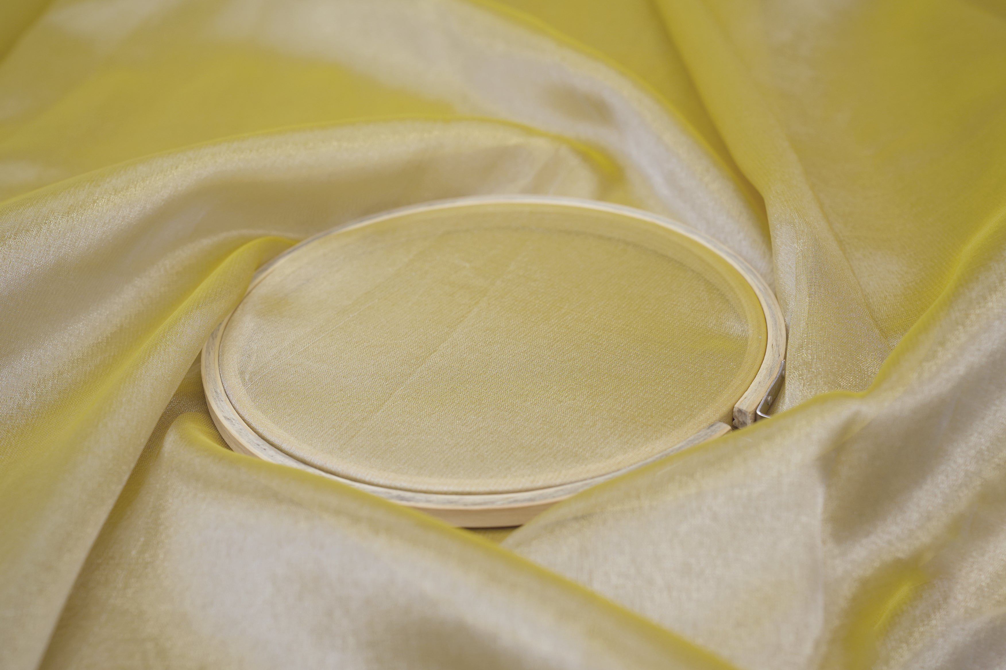 Lemon coloured tissue fabric with silver shimmer