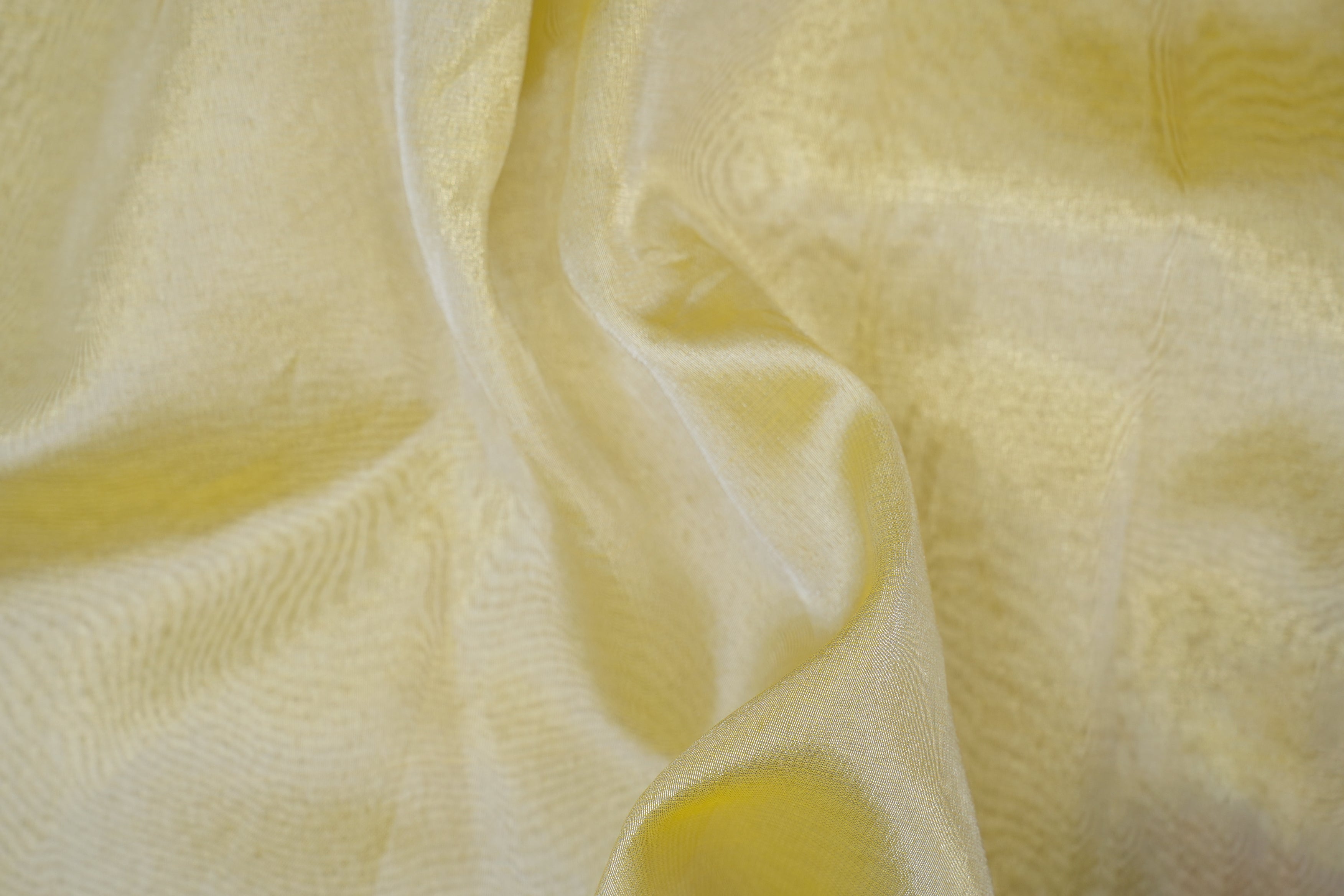 Lemon coloured tissue fabric with silver shimmer