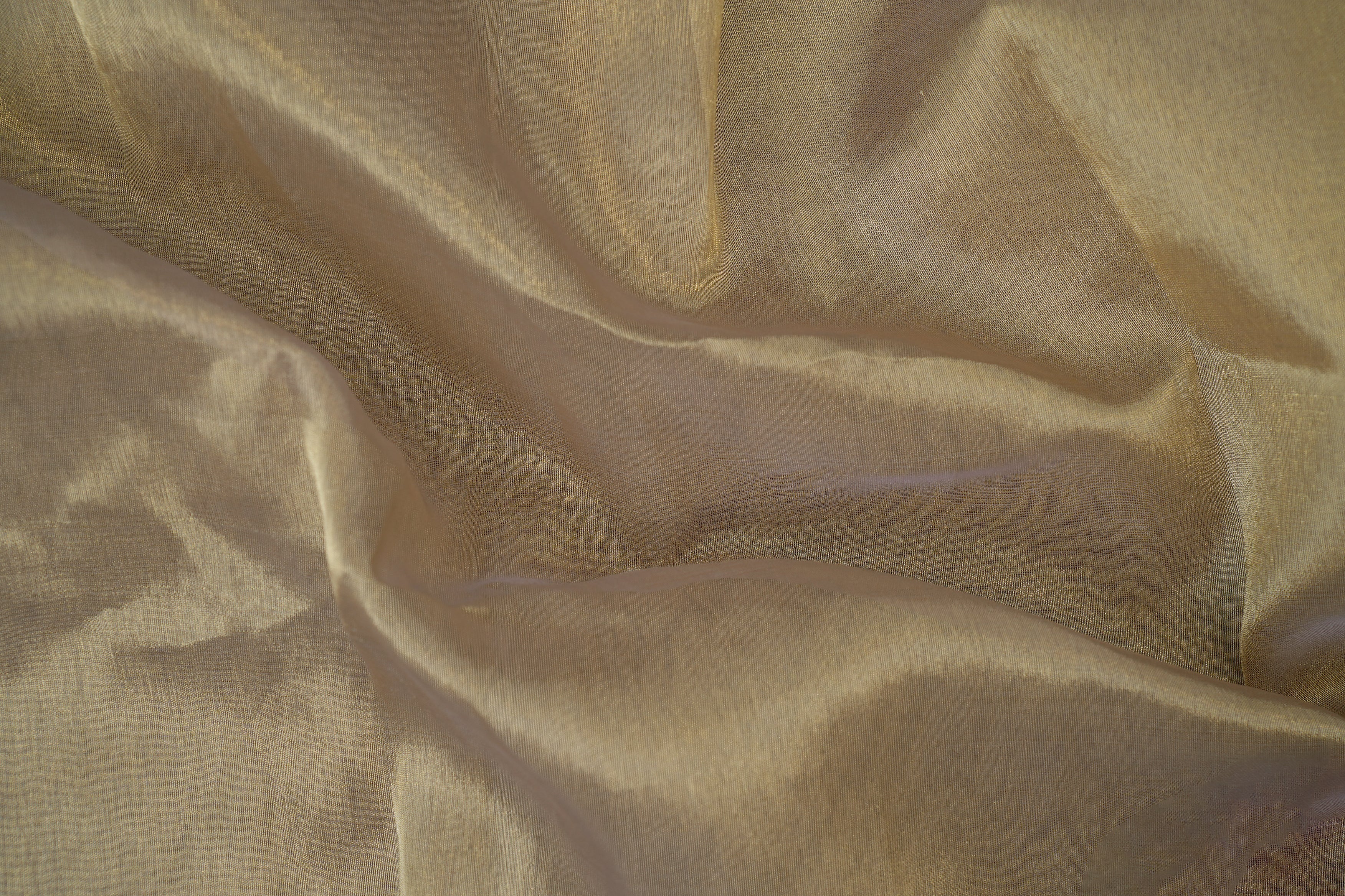 Light gold coloured tissue fabric with golden shimmer