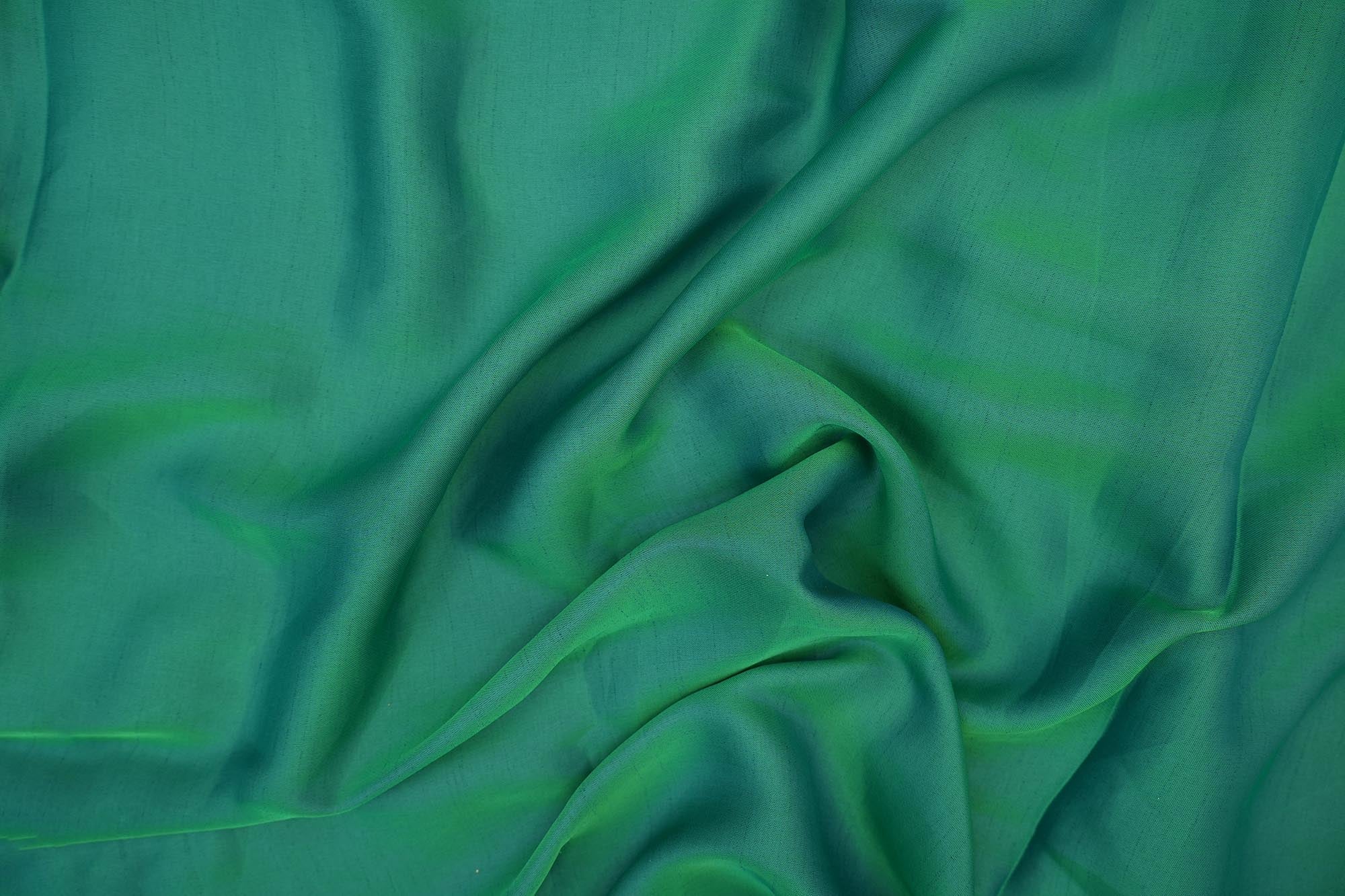 Emerald green coloured barfi silk fabric