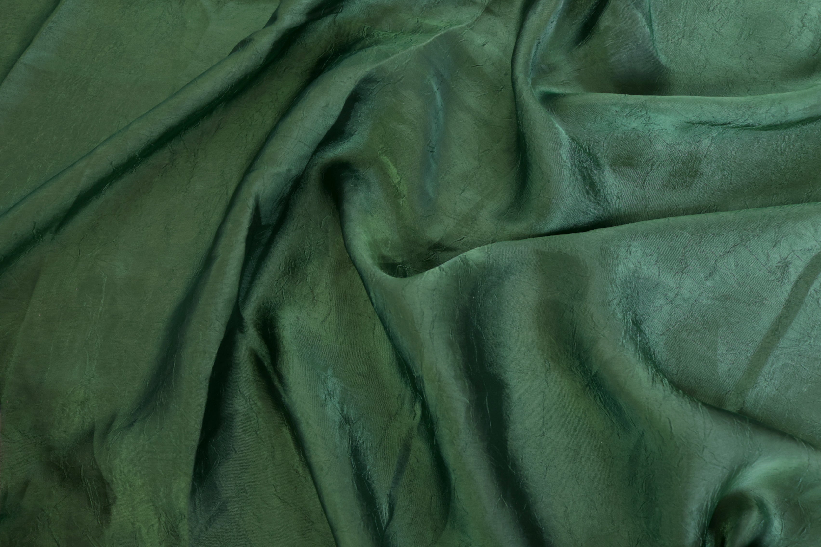 Dark green coloured silk crushed texture fabric