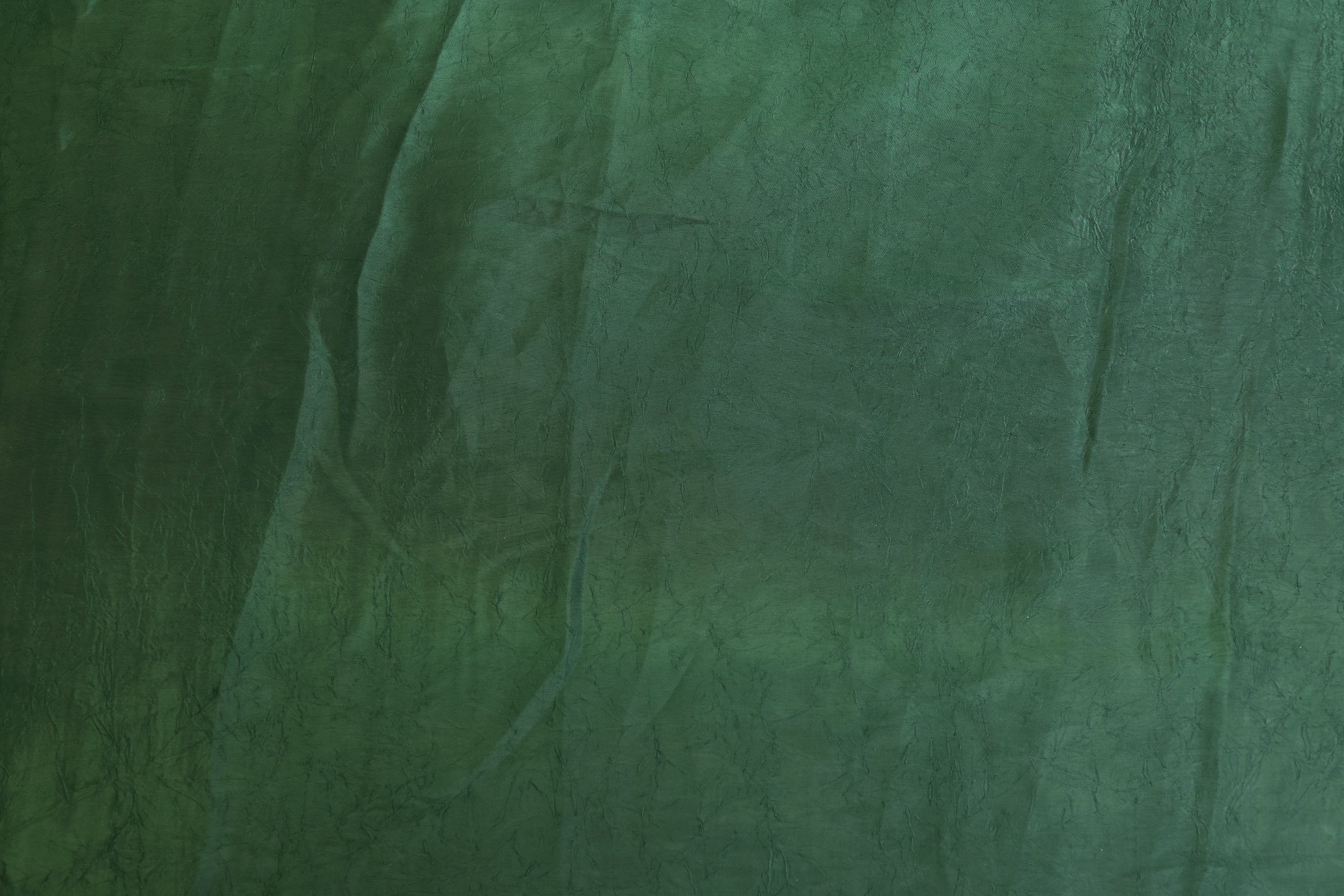 Dark green coloured silk crushed texture fabric