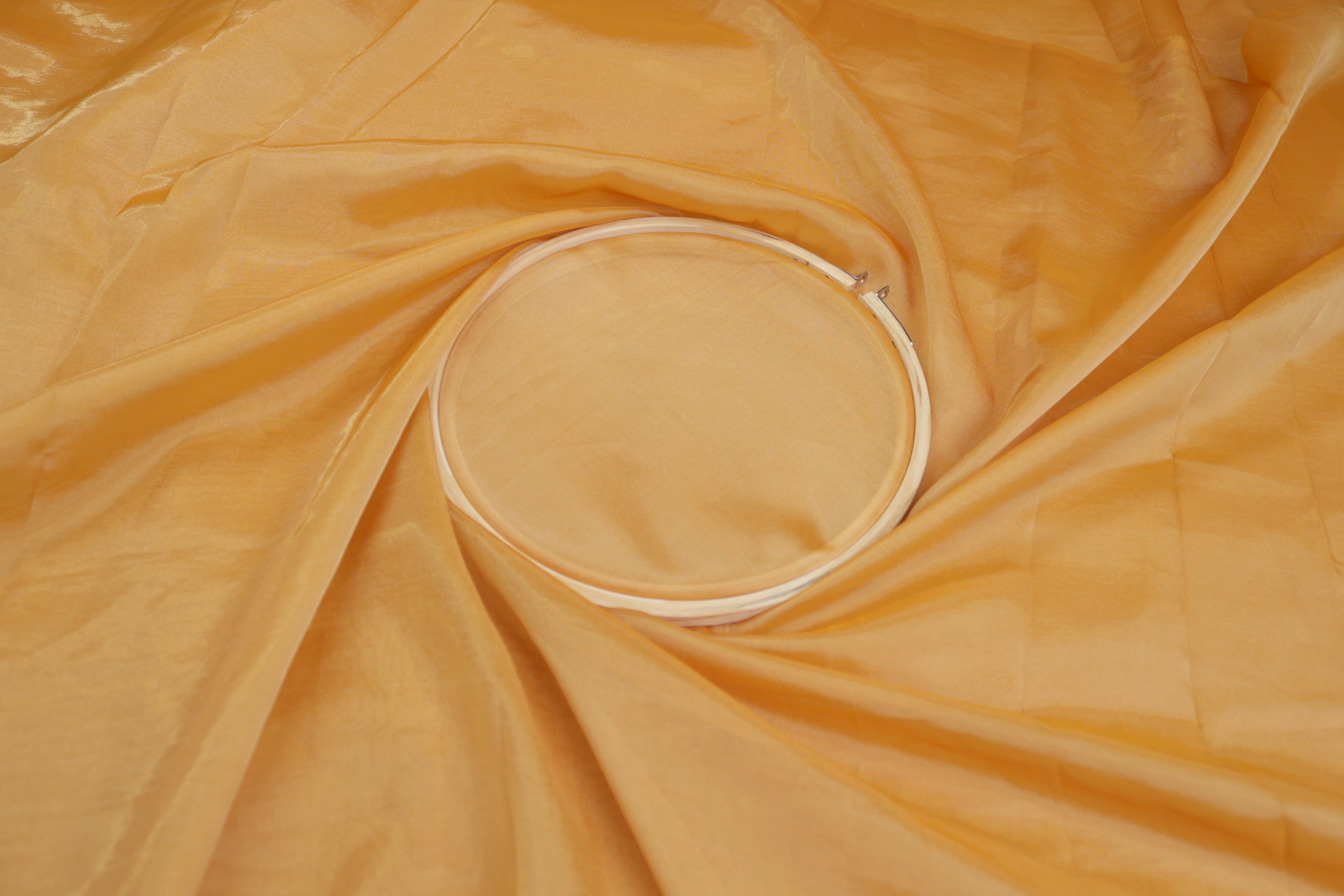 Mustard light coloured Soft tissue tissue fabric with gold shimmer