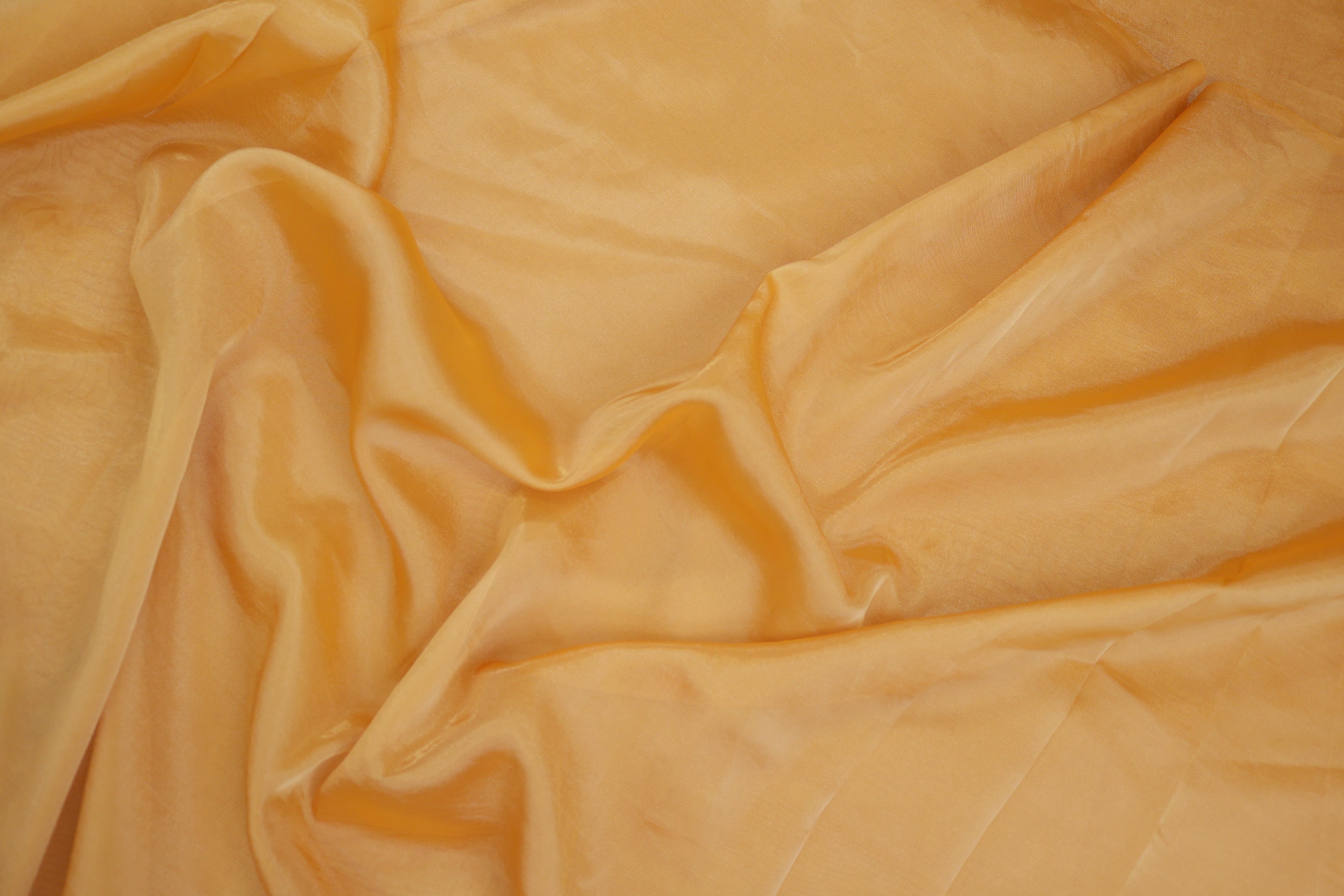 Mustard light coloured Soft tissue tissue fabric with gold shimmer