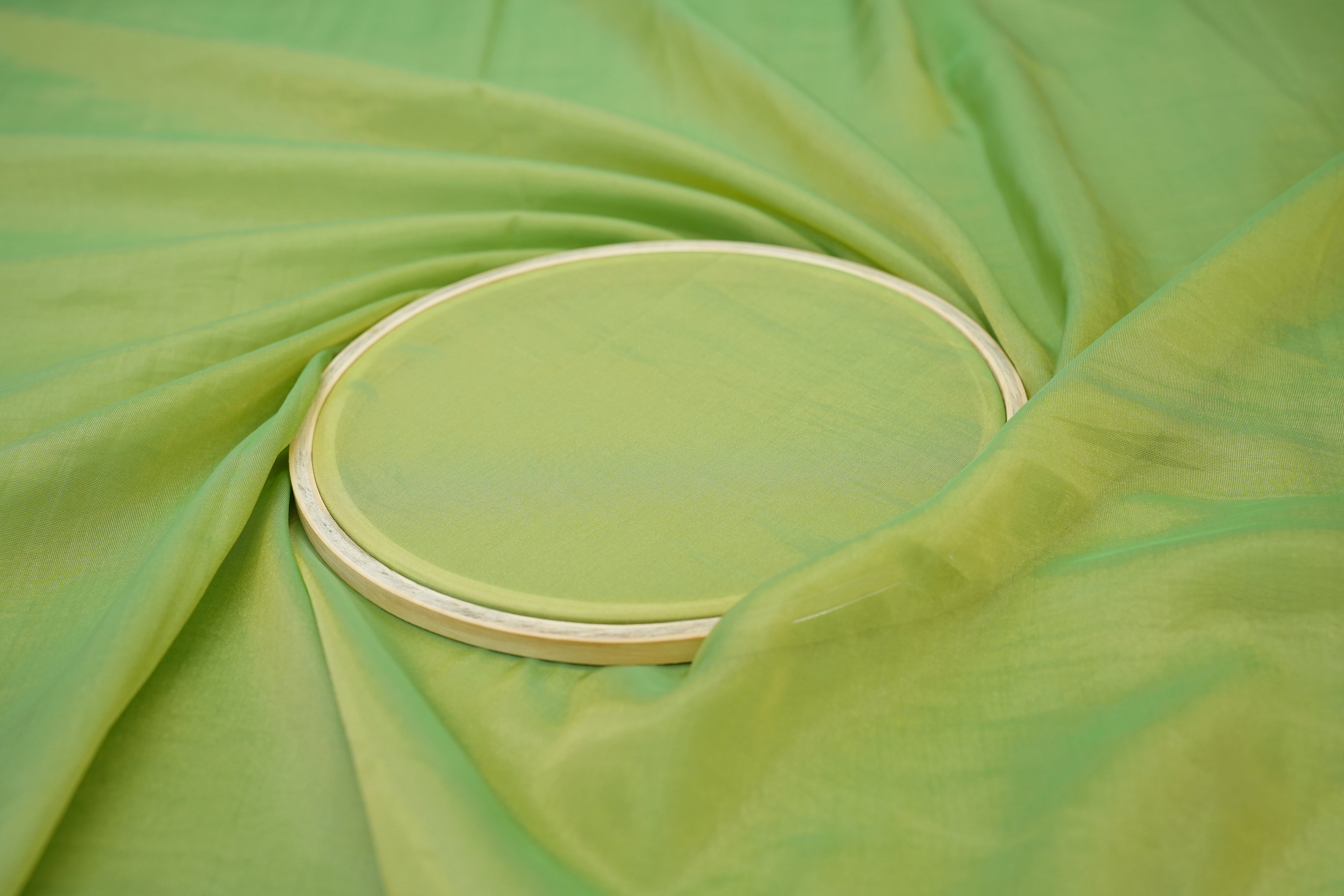 Pista green coloured Soft tissue tissue fabric with gold shimmer