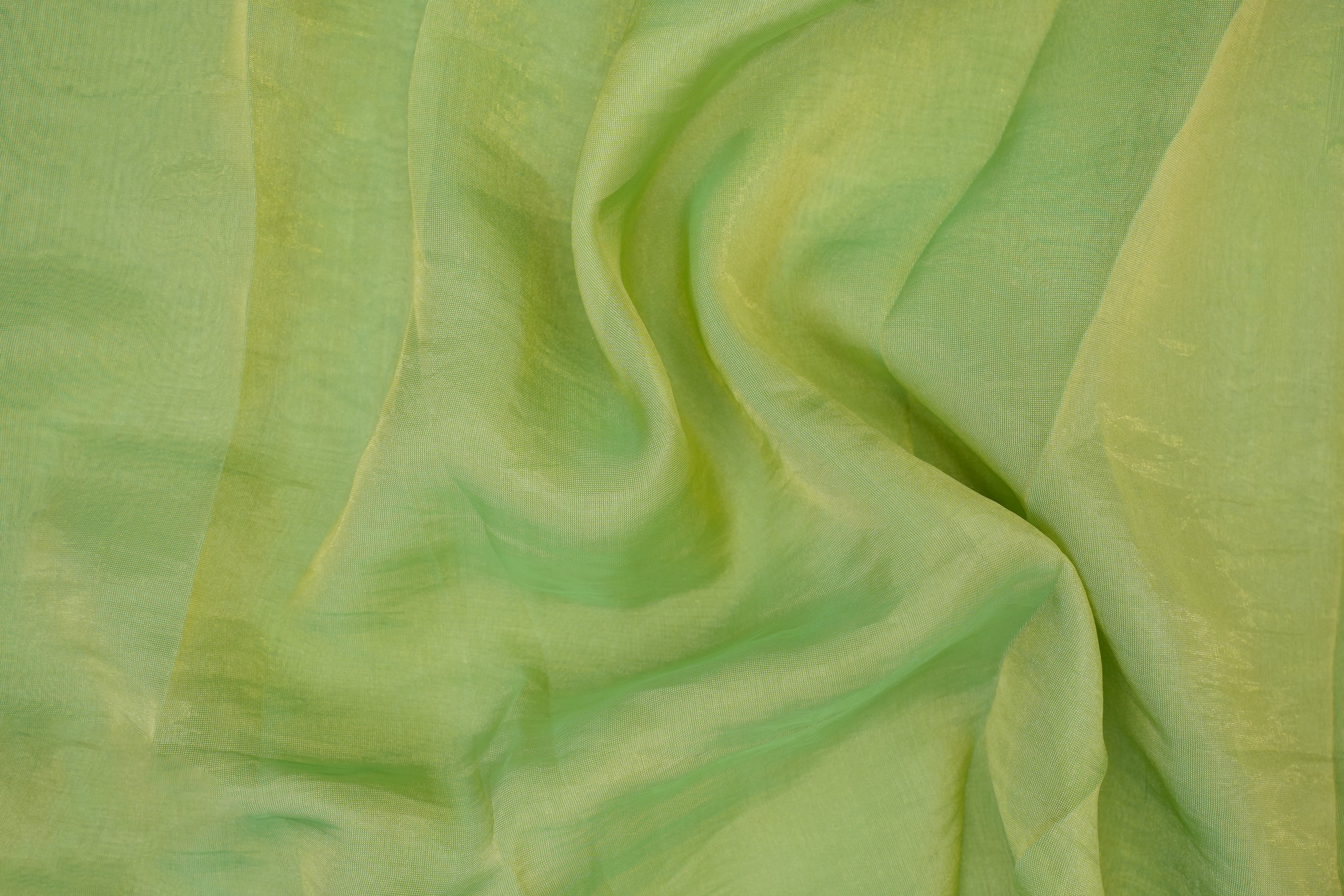 Pista green coloured Soft tissue tissue fabric with gold shimmer