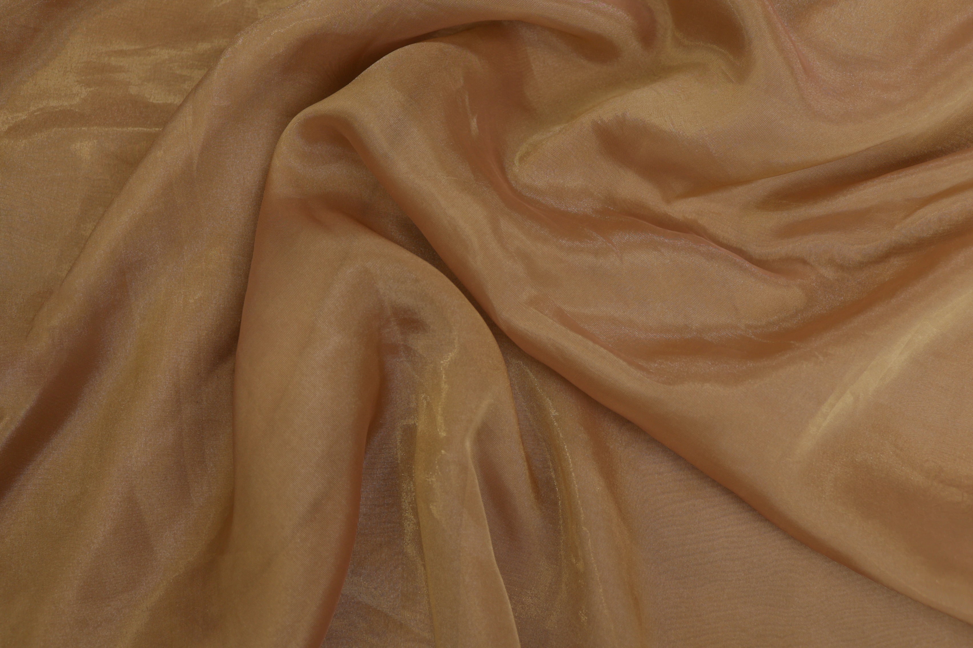 Light brown coloured Soft tissue tissue fabric with gold shimmer