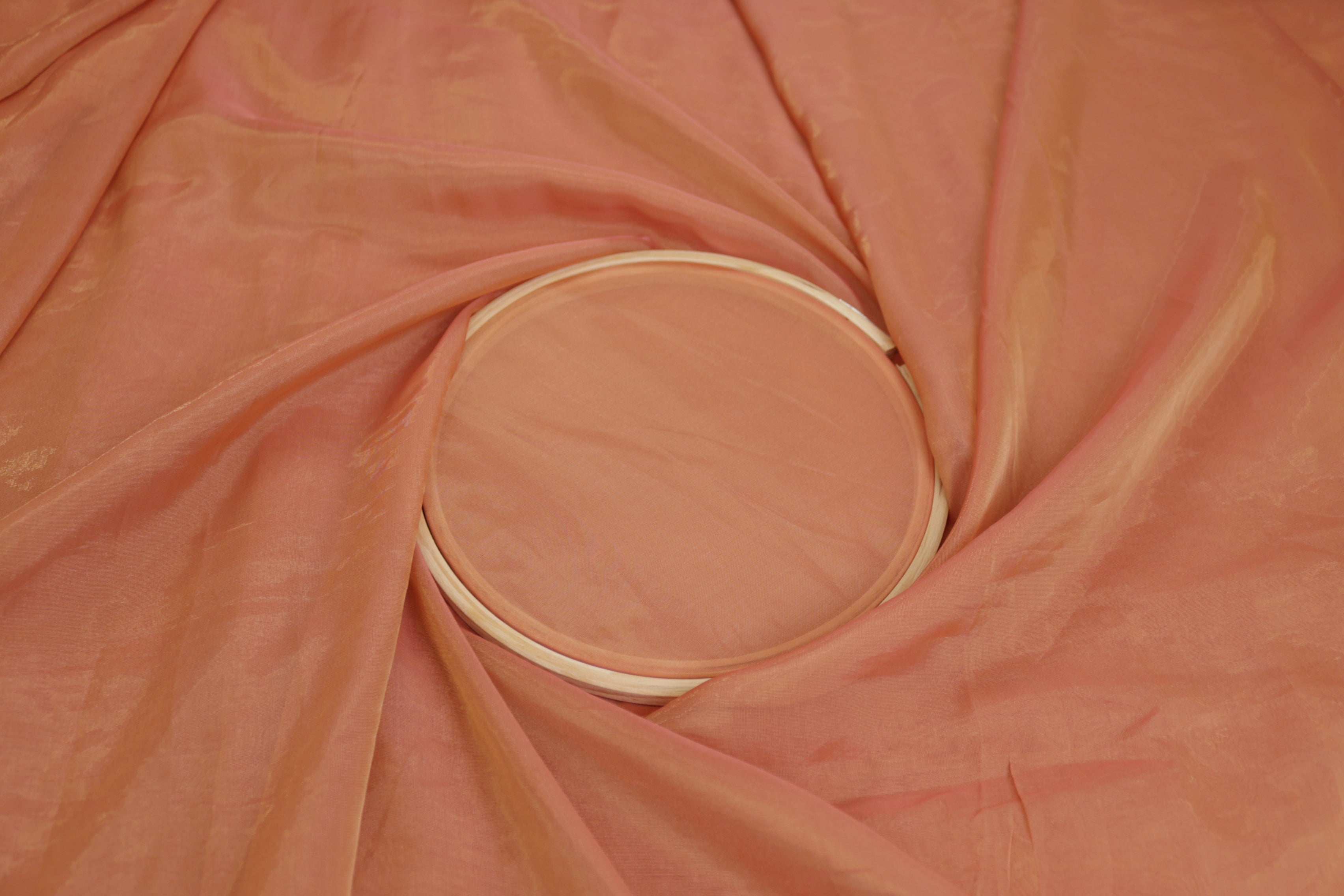 Peach pink coloured Soft tissue tissue fabric with gold shimmer