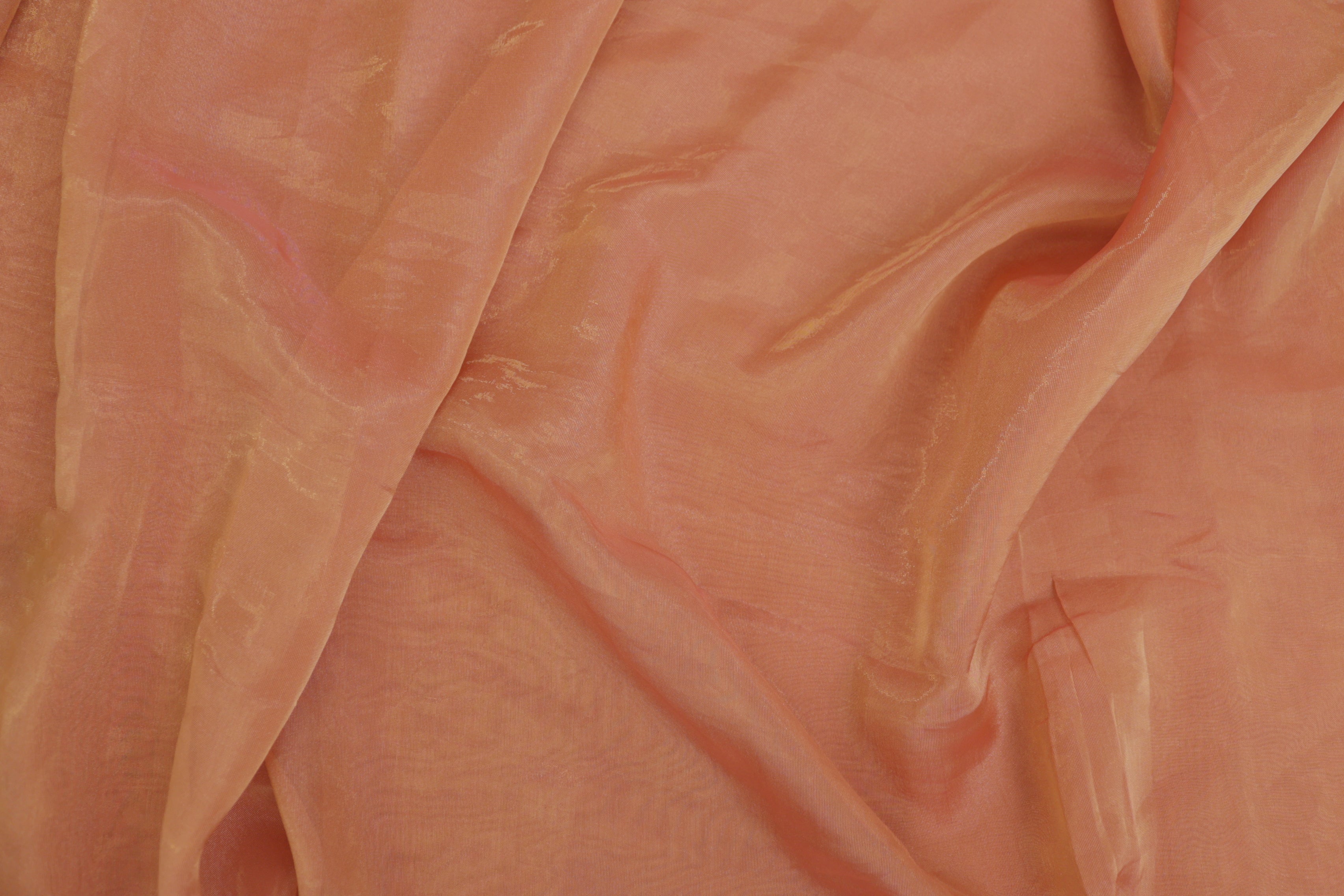 Peach pink coloured Soft tissue tissue fabric with gold shimmer