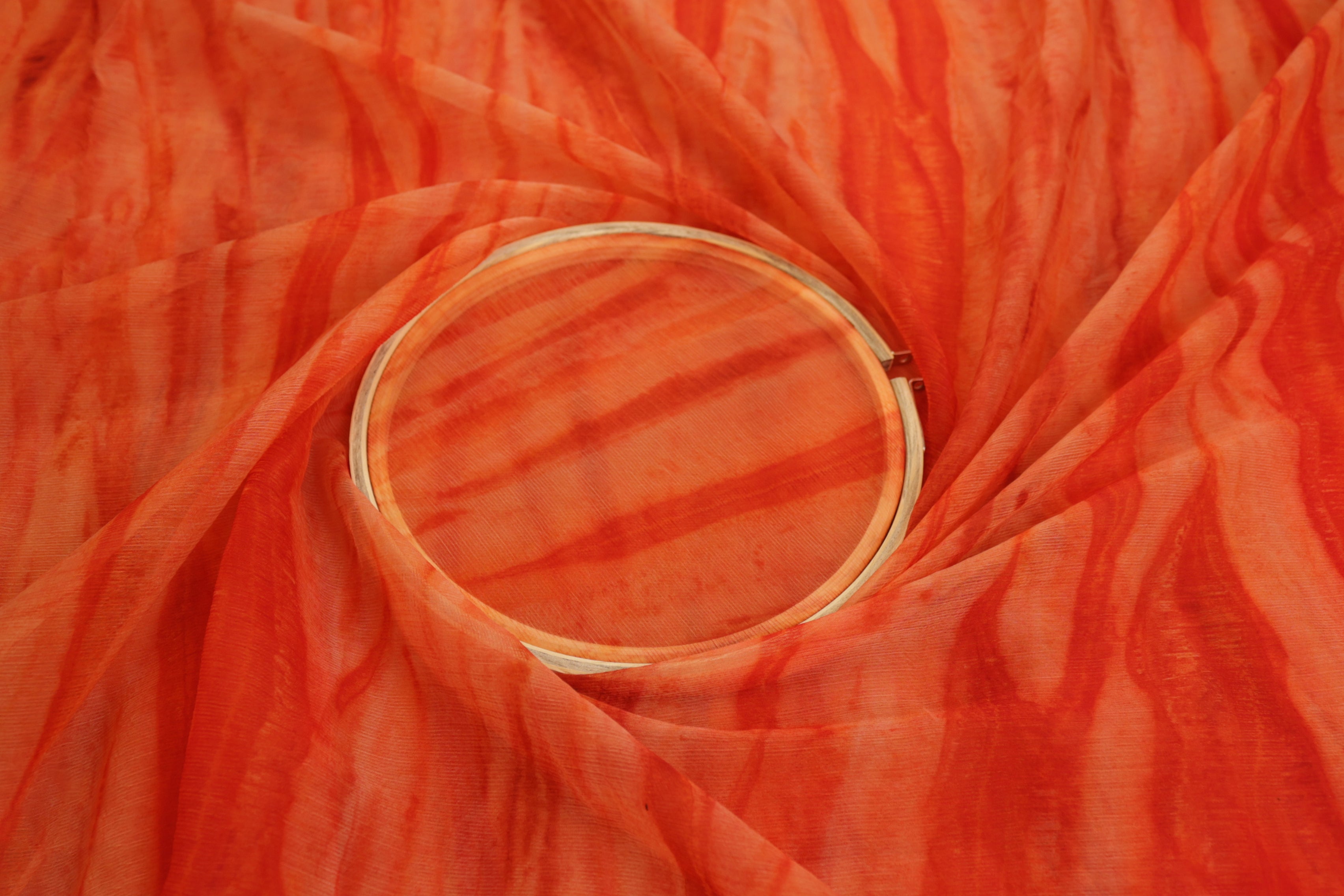 Burnt orange coloured textured chiffon fabric