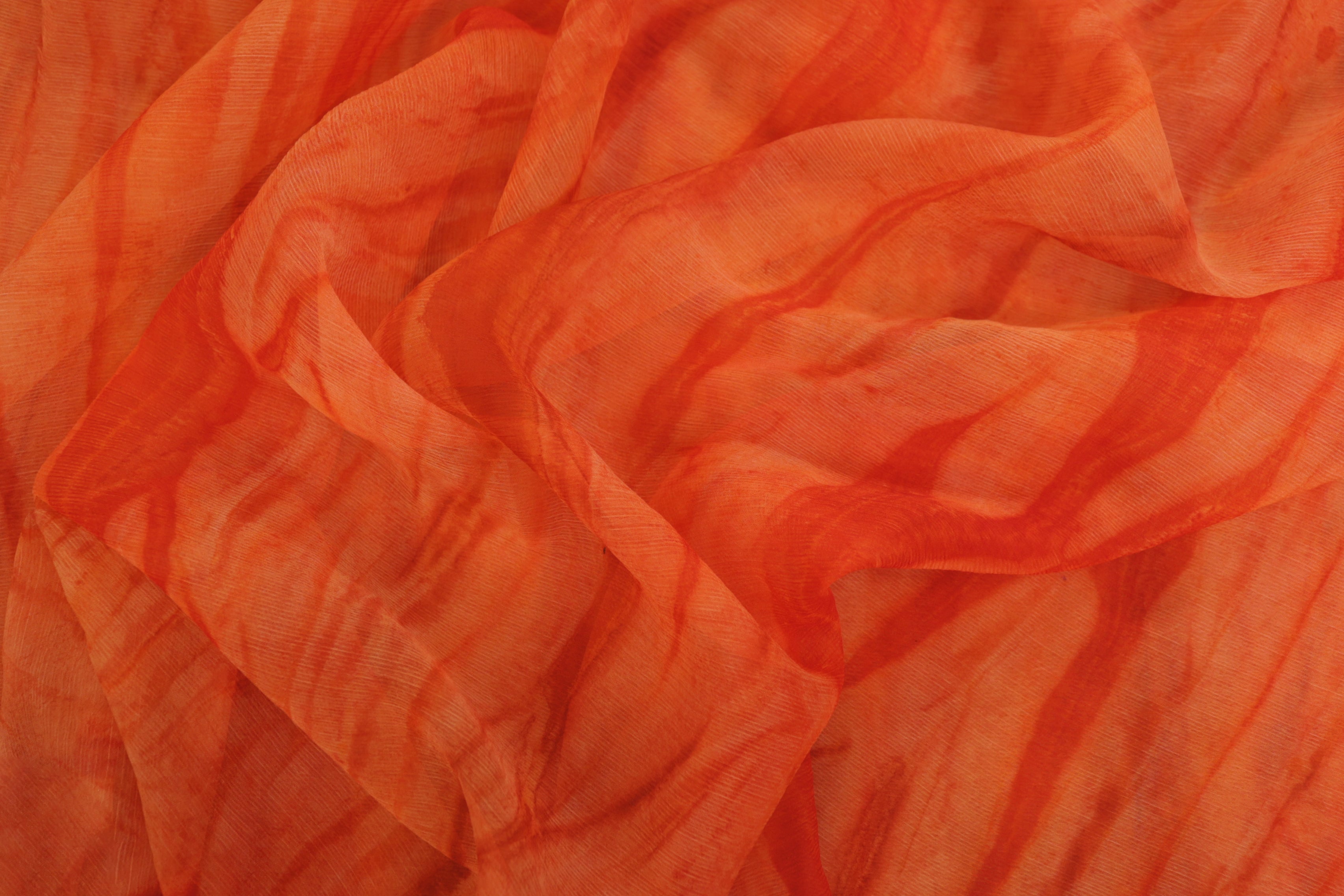 Burnt orange coloured textured chiffon fabric