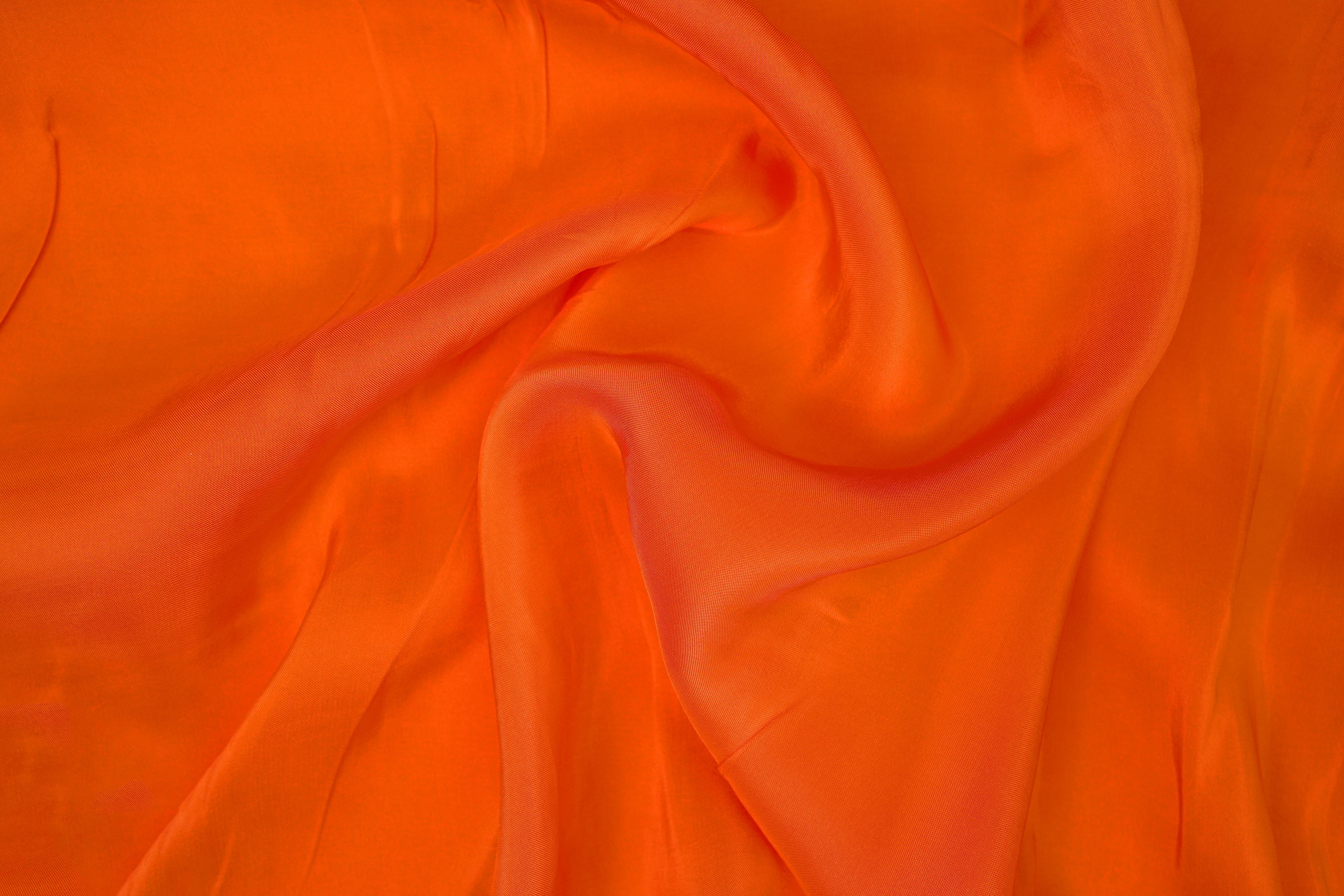 Neon orange coloured upada silk fabric