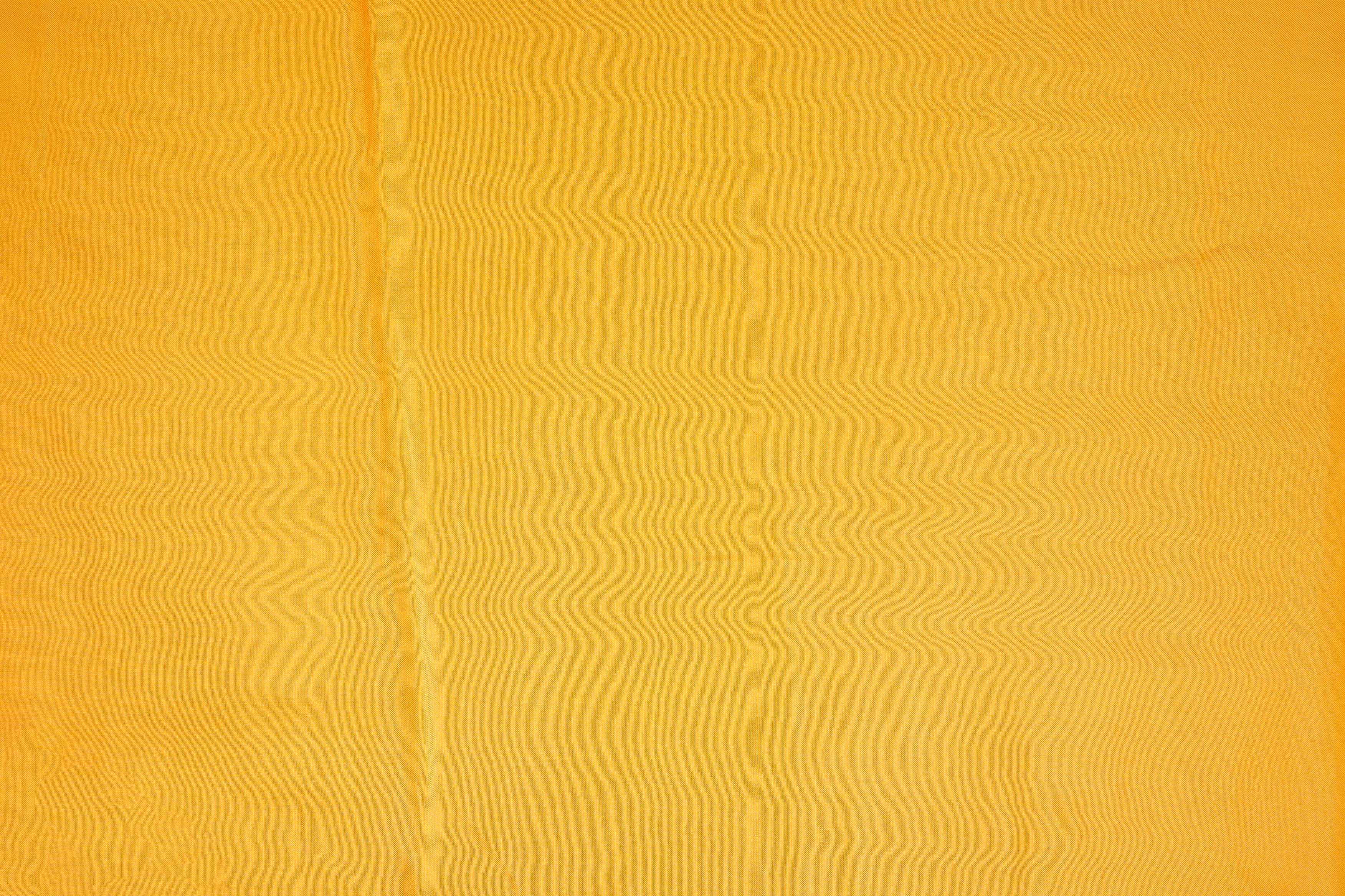 Bright yellow coloured upada silk fabric