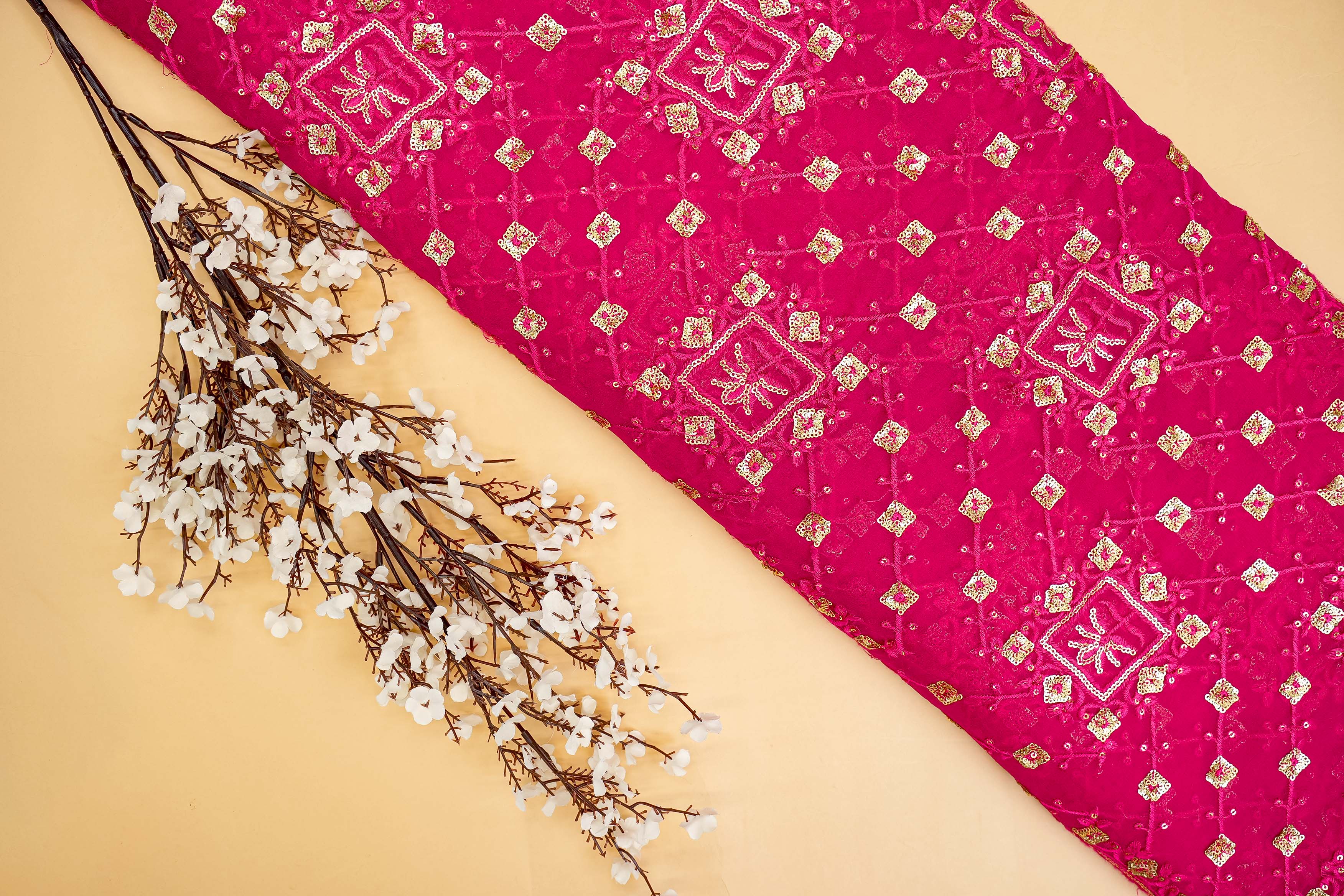 Pink georgette fabric with thread with golden sequins creating geometric allover pattern